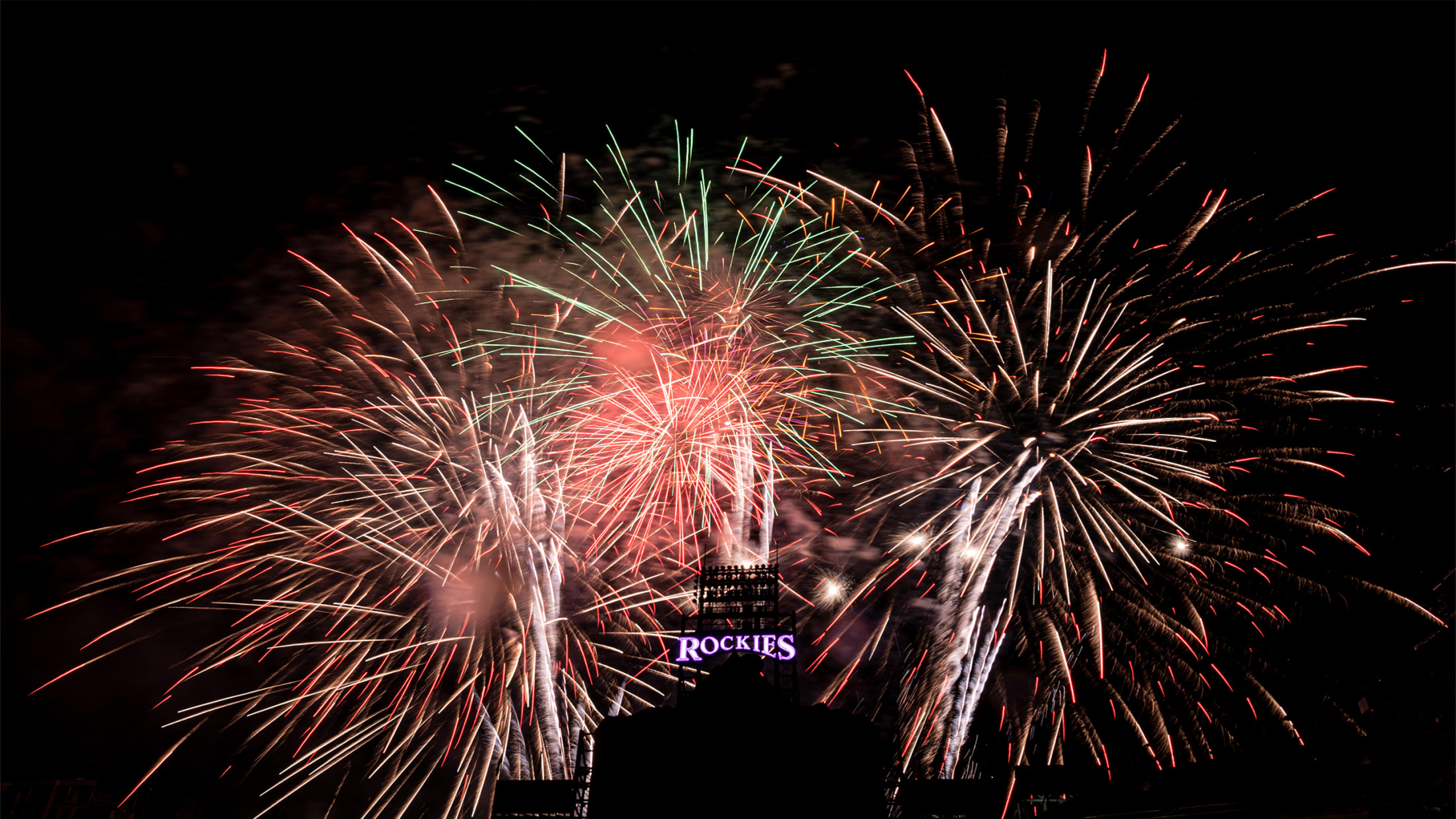 Post game firework show lights up the sky above the main scoreboard