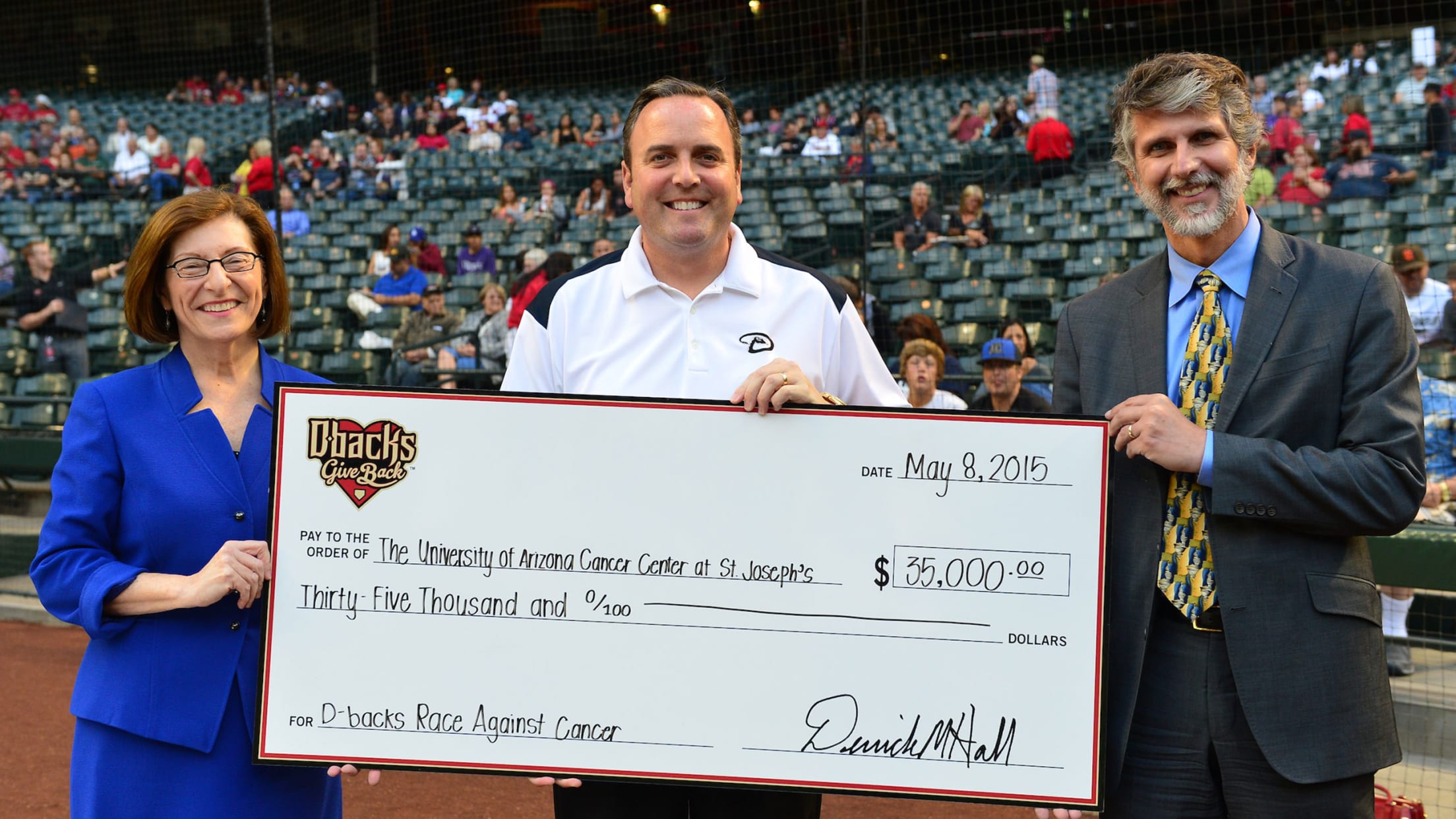 Derrick Hall presenting a check