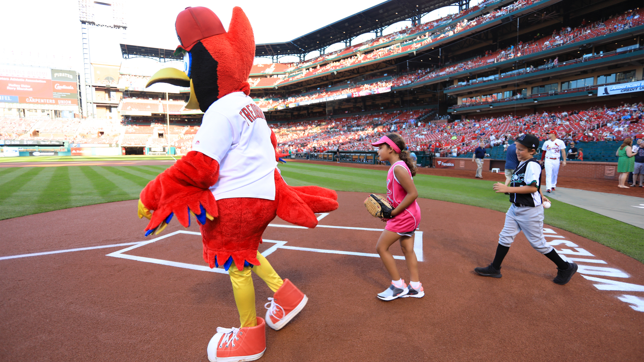 Redbird on field with kids
