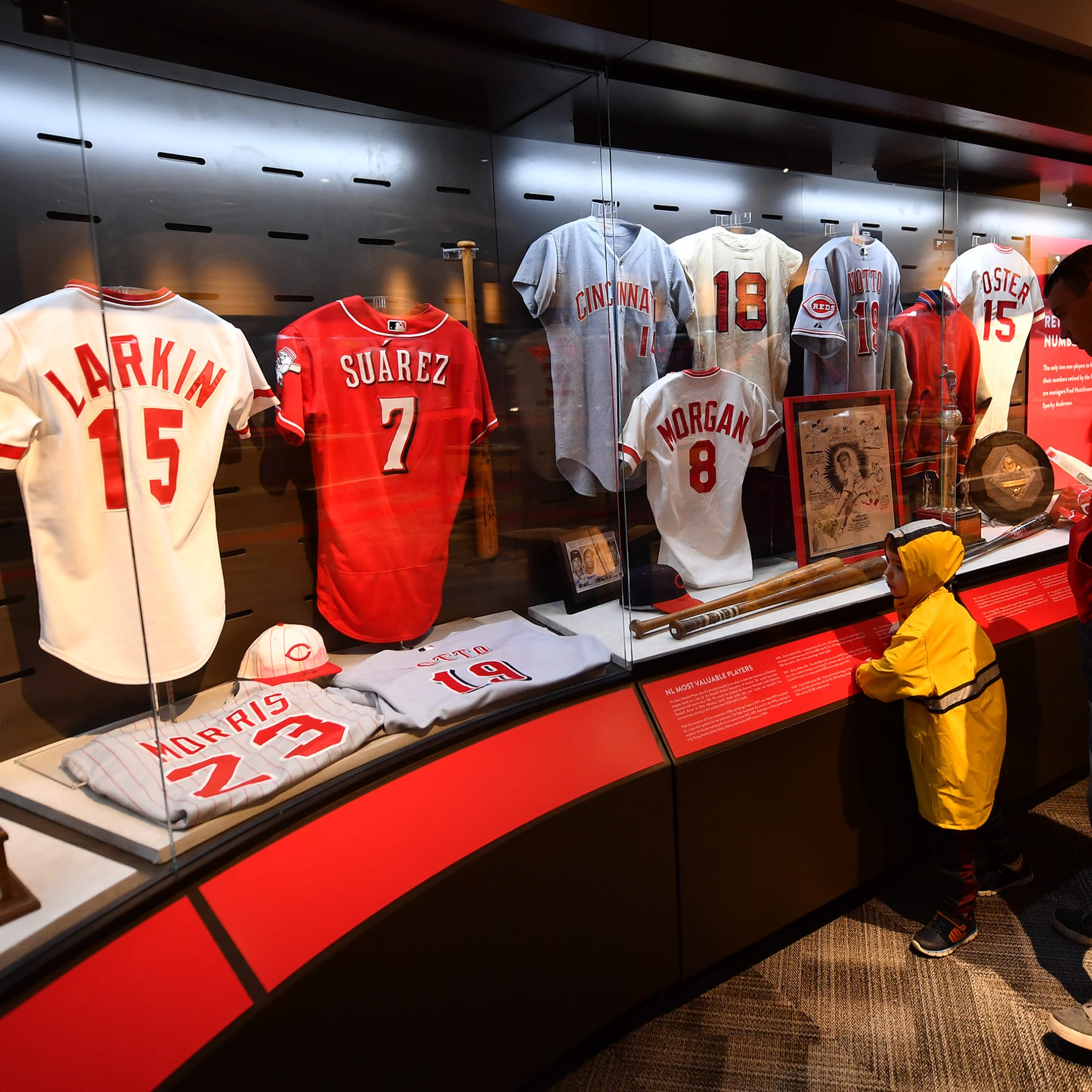 Reds Kids Club member using their free Reds Hall of Fame and Museum admission and marveling at a jersey display.