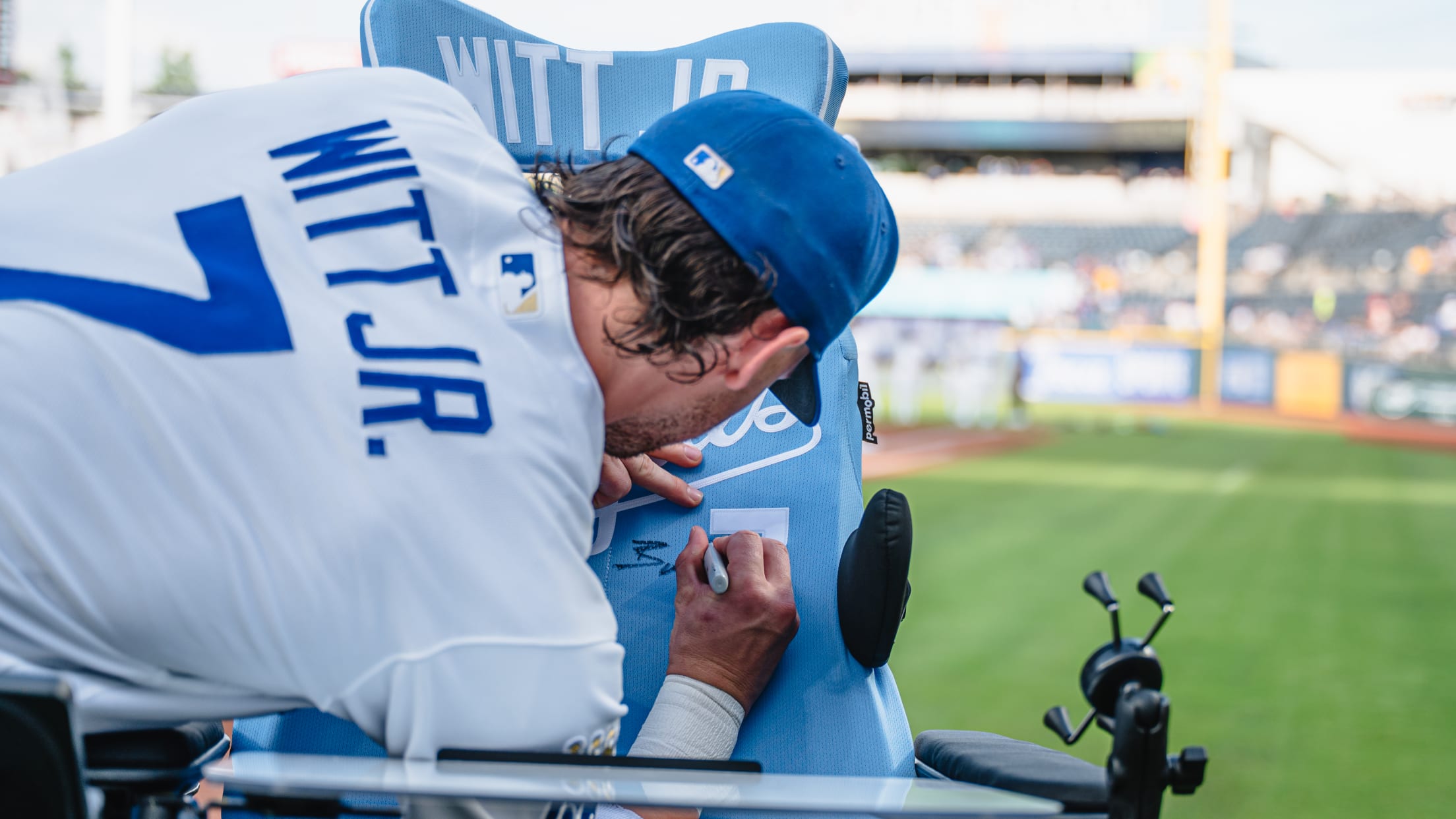 Bobby Witt Jr. signs a specialized wheelchair.