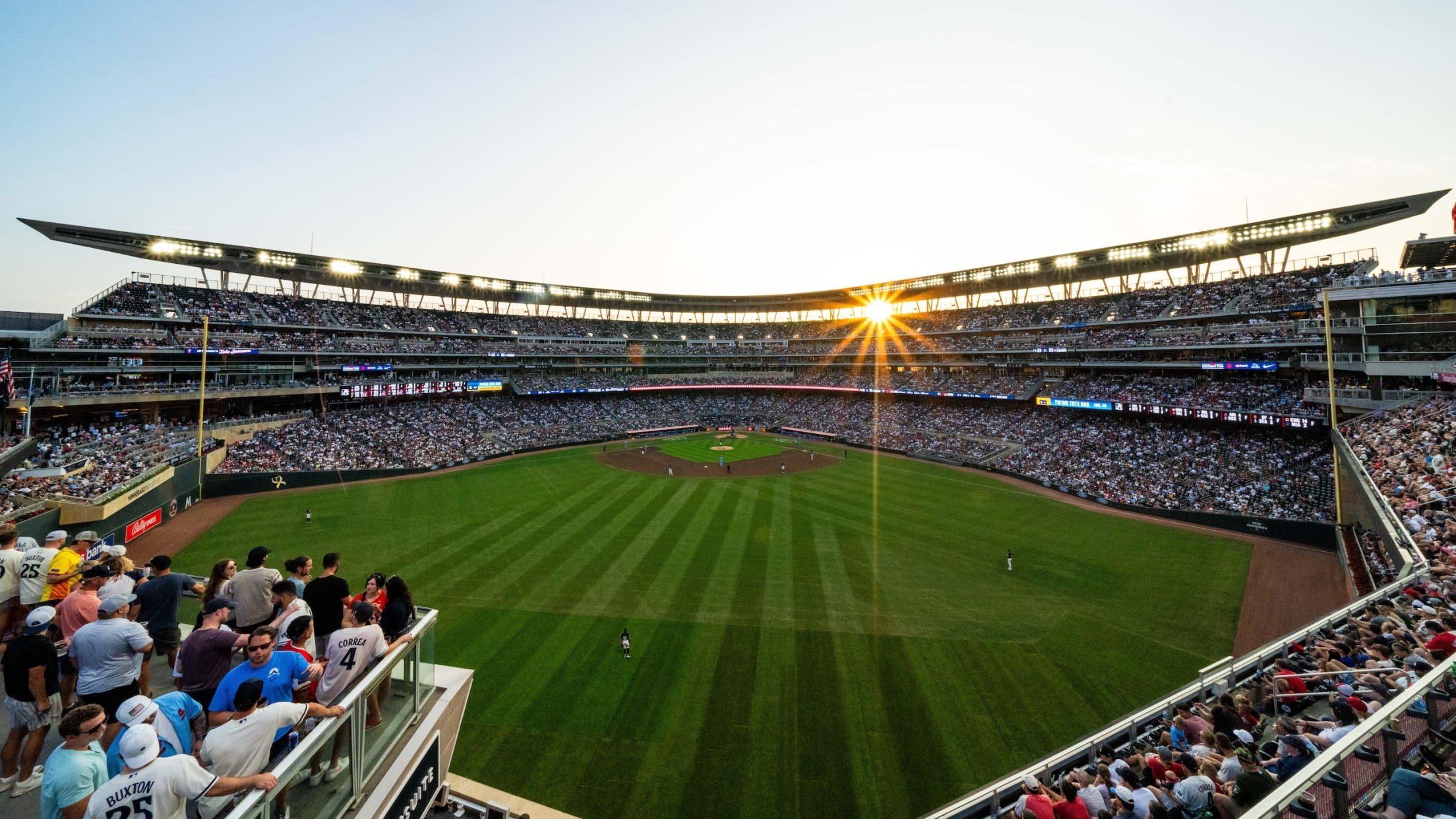 View of Target Field from stands looking towards home plate with evening sun reflecting in the background