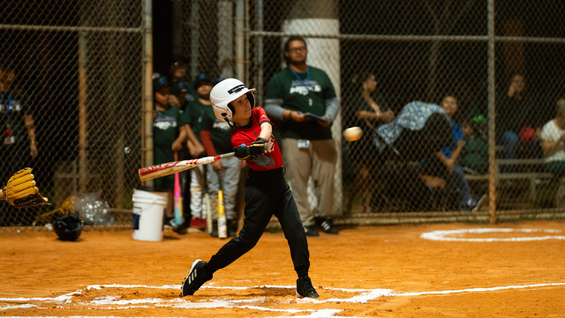 A young batter swings at the pitch during the Miami Marlins MLB Youth Academy.