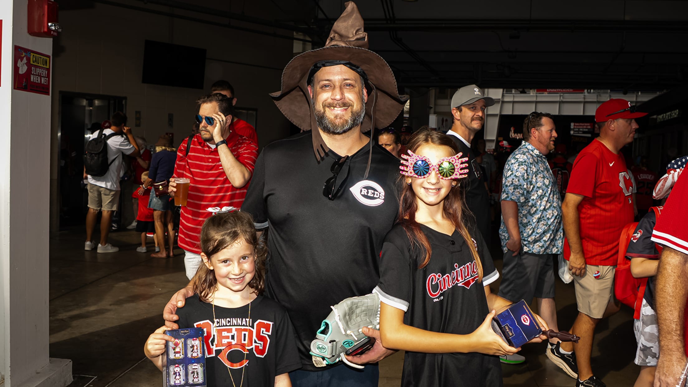 Family dressed in Harry Potter™ attire with their bobbleheads.
