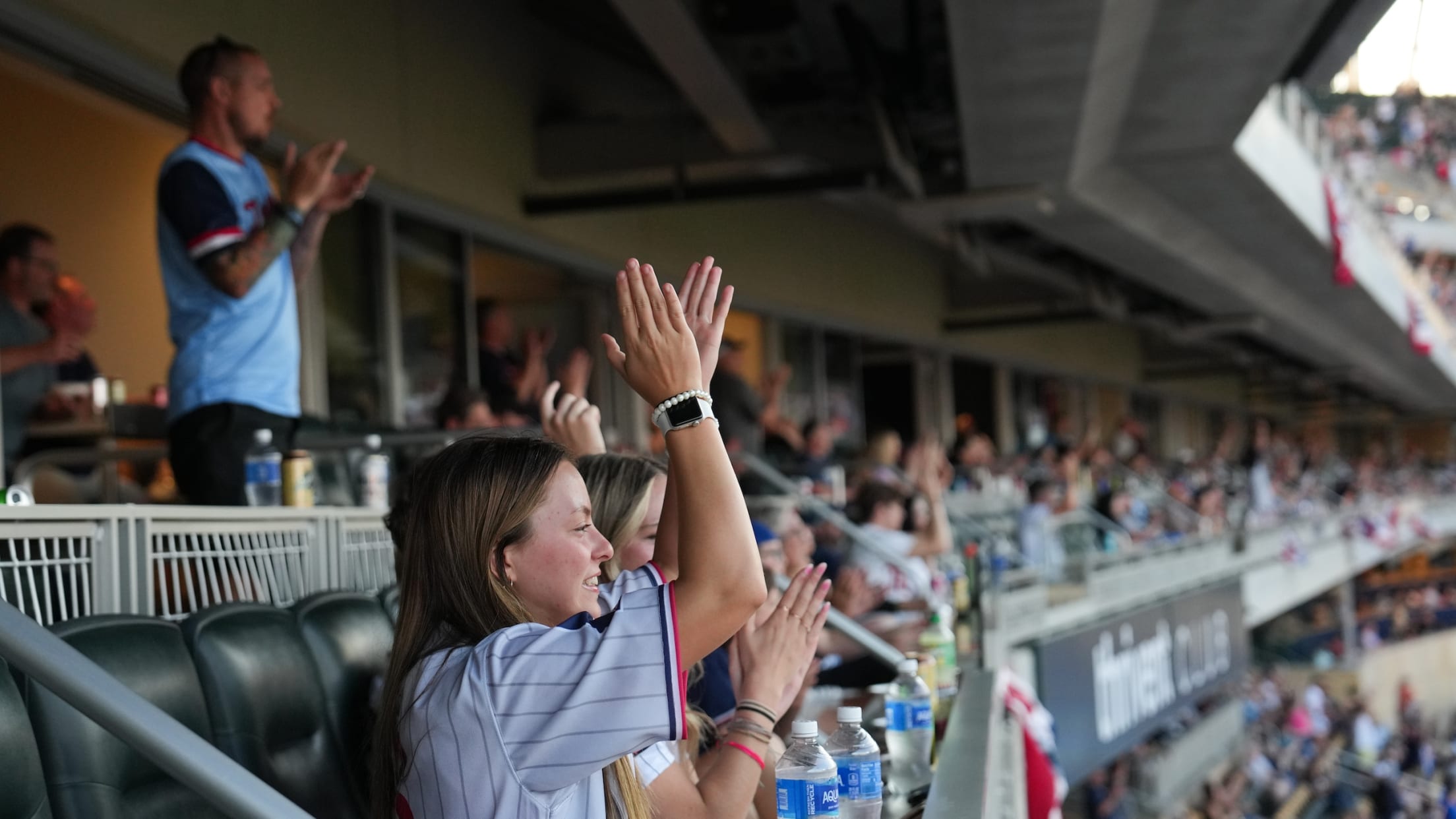 Fans celebrating a big play in a Target Field Suite