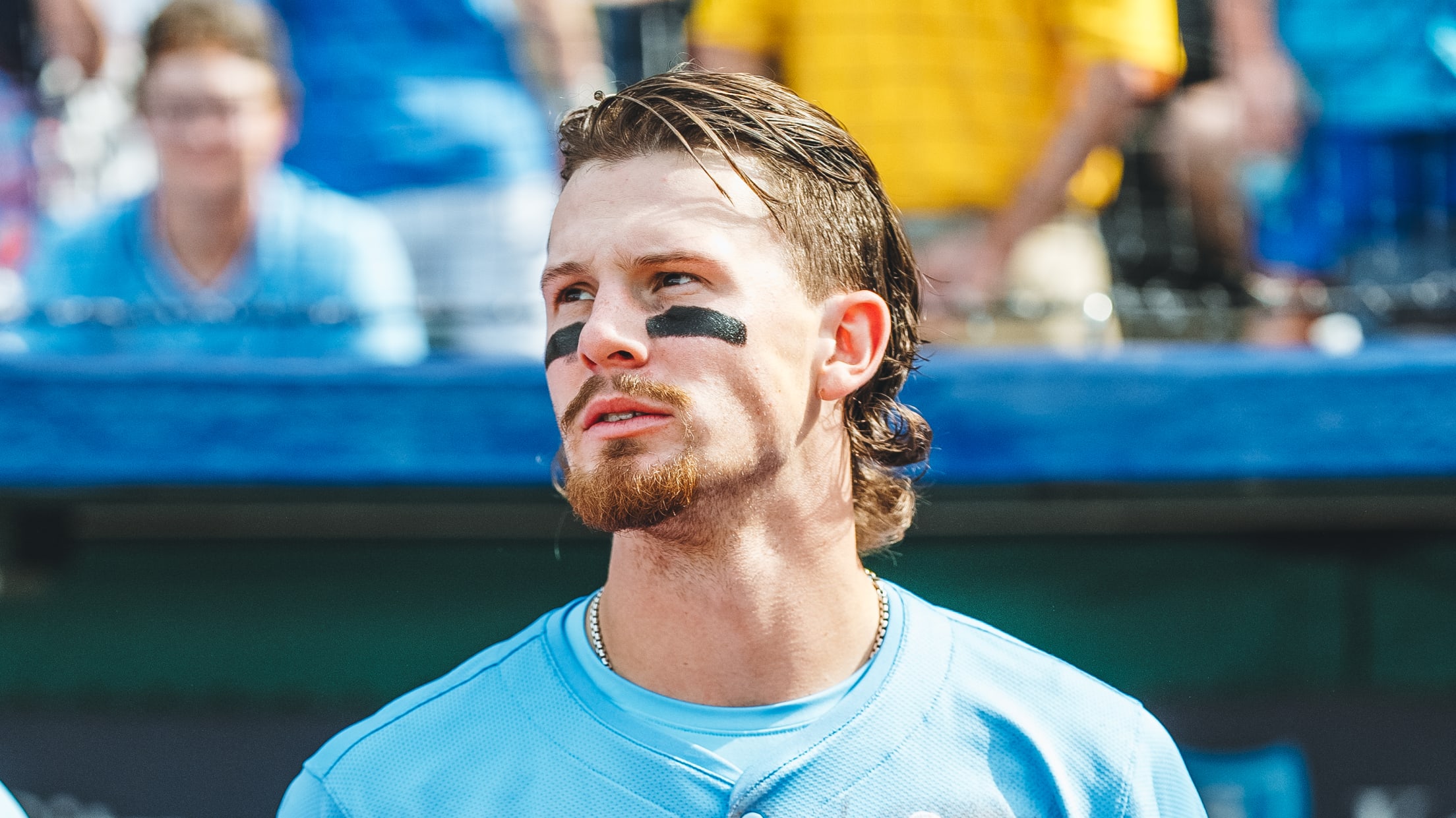 Bobby Witt Jr. holds a sign that says "We Give Hope To All" during a ceremony at Kauffman Field.