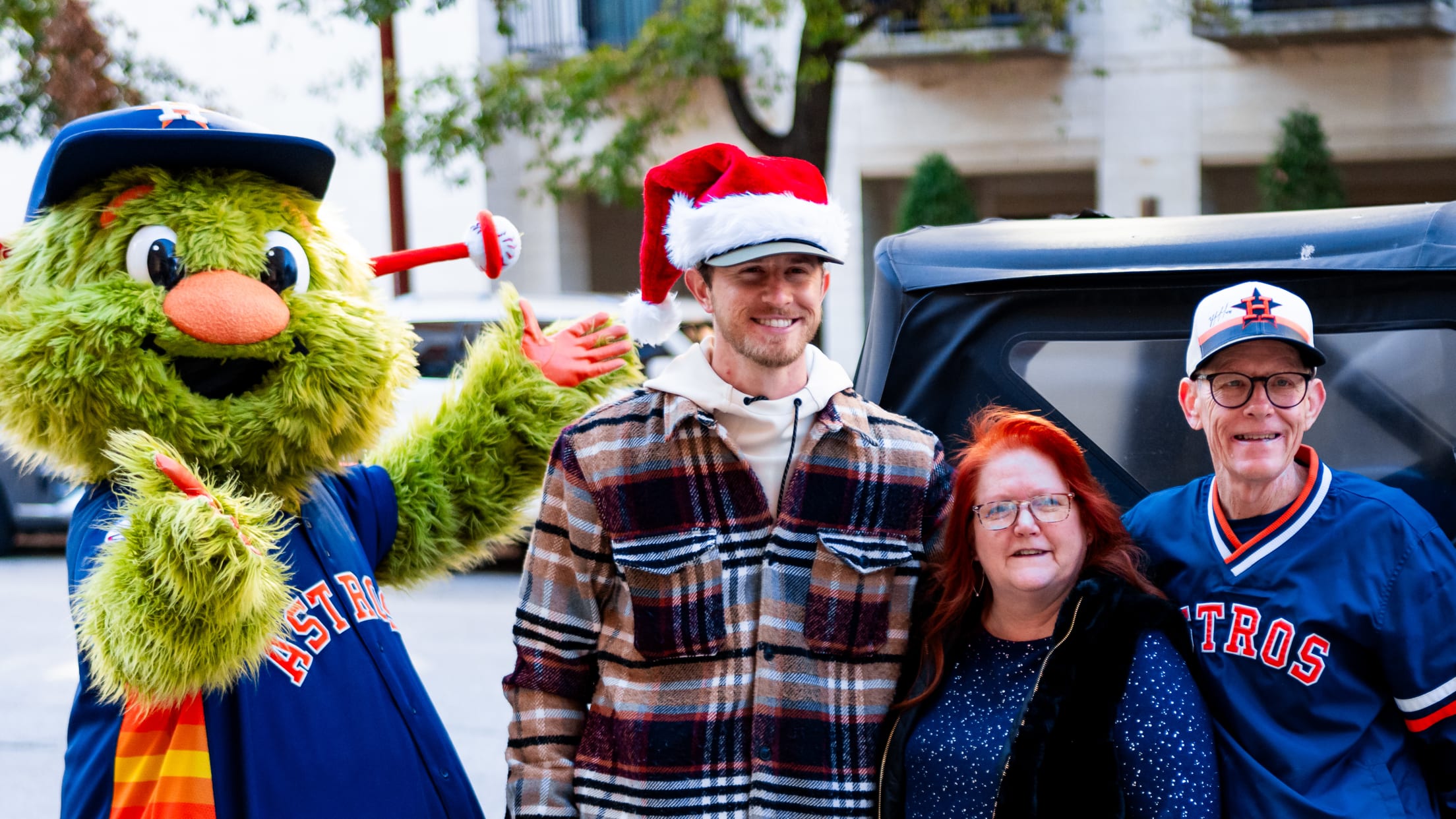 Josh Hader takes a photo with Houston Astros fans and Orbit.