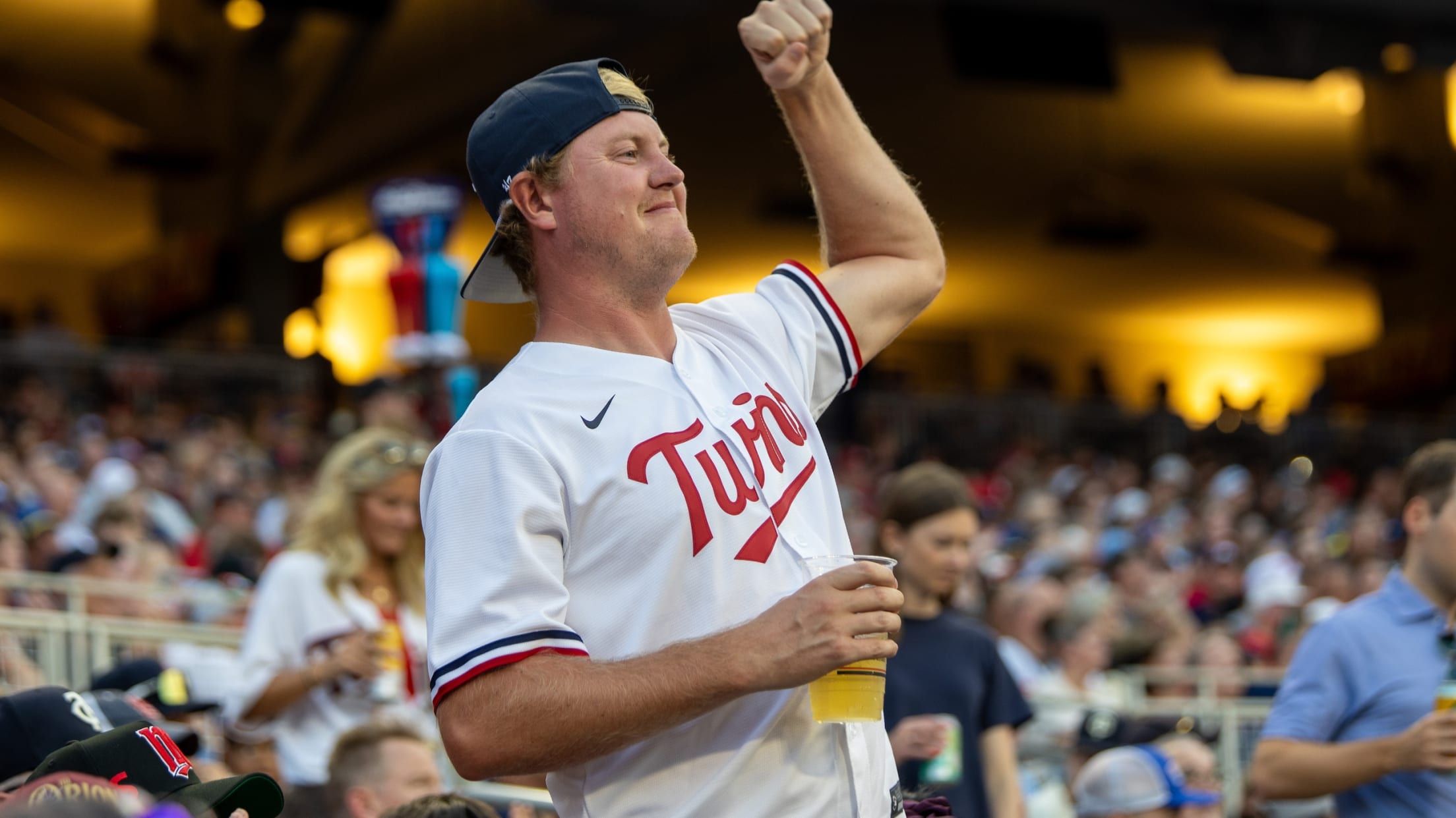 Twins fan in stand at Target Field celebrating