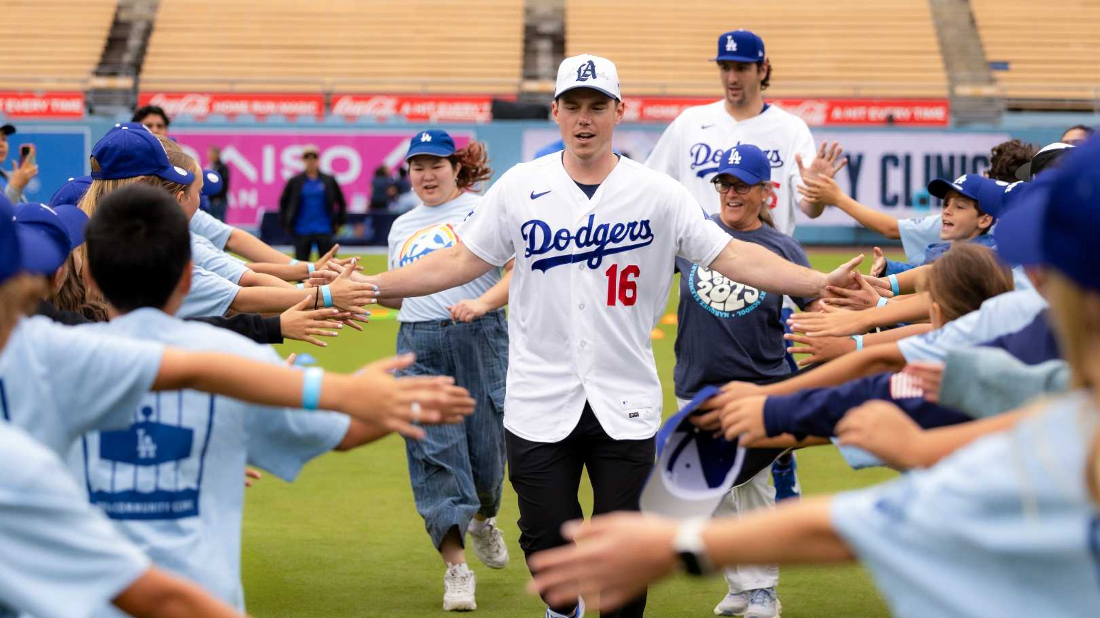 Will Smith high fives young fans of the Los Angeles Dodgers at an event at Dodger Stadium.