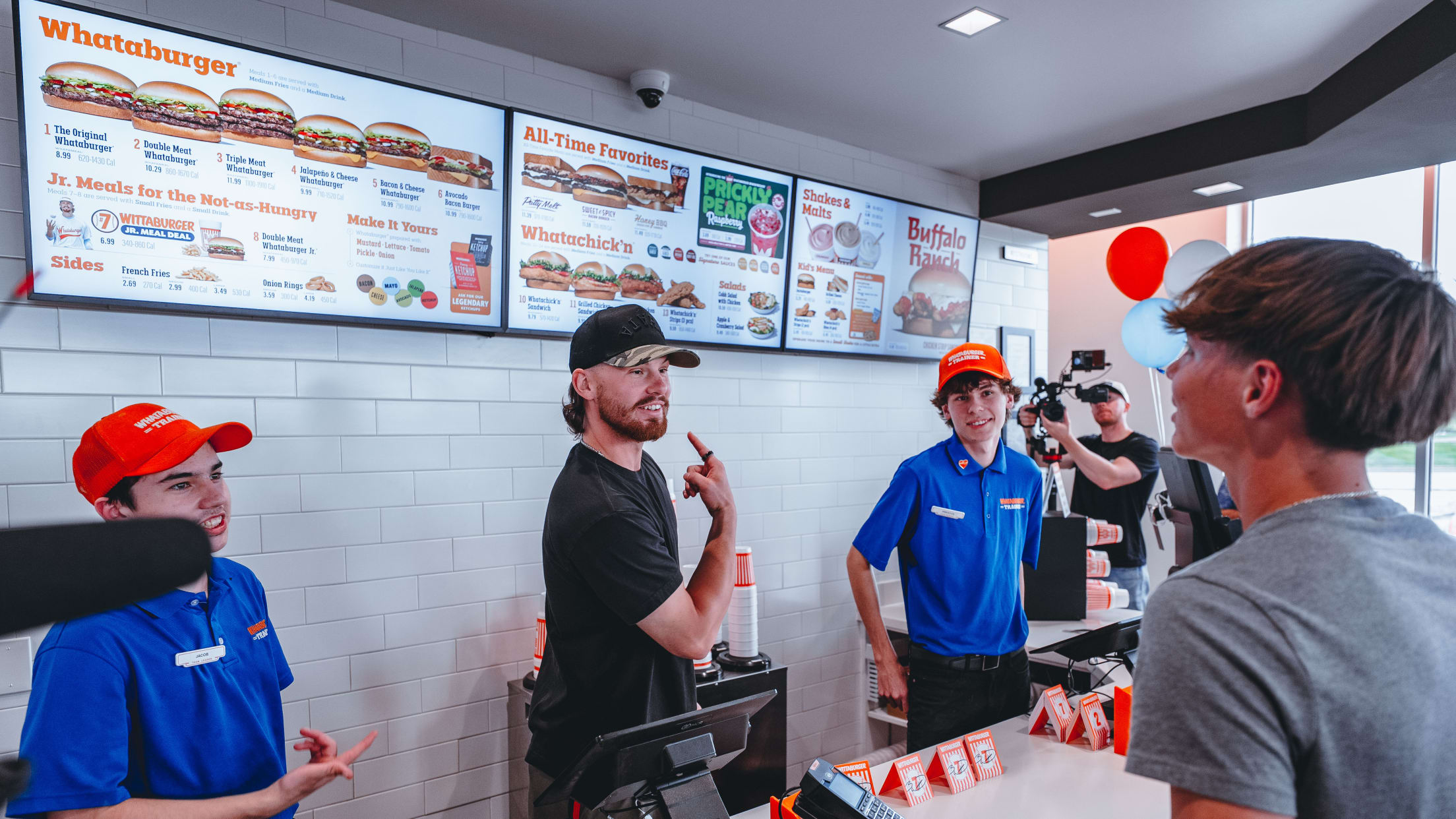 Bobby Witt Jr. takes an order from a customer at Whataburger.