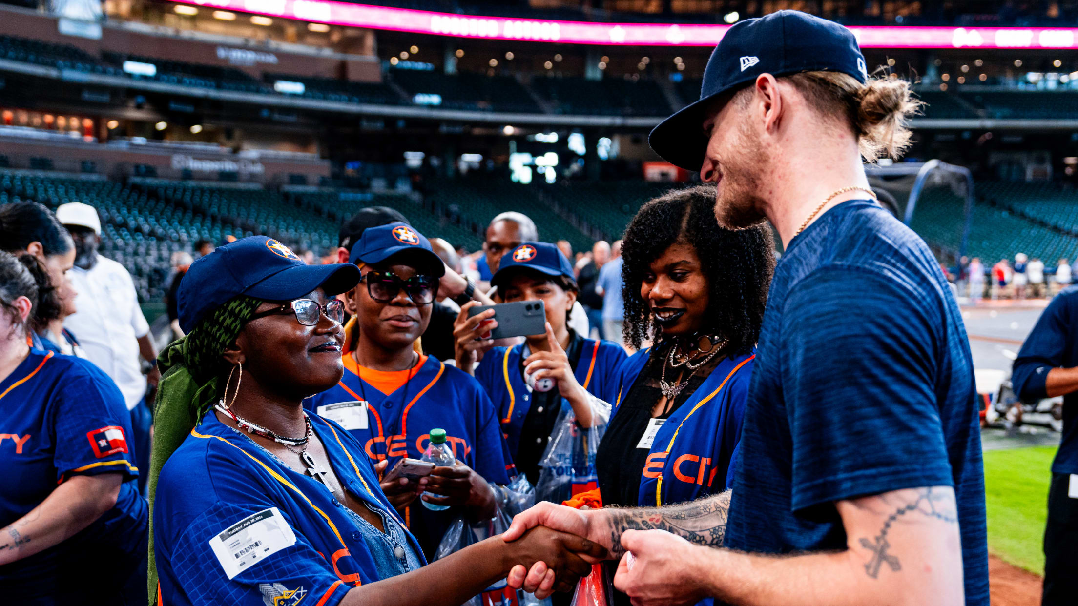 Josh Hader shakes hands with Houston Astros fans at Daikin Park.