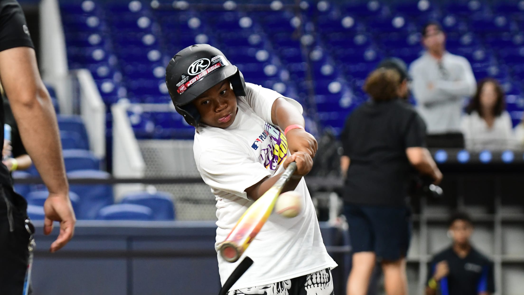 A player swings the bat in the batter's box at Pitch, Hit & Run at loanDepot Park.