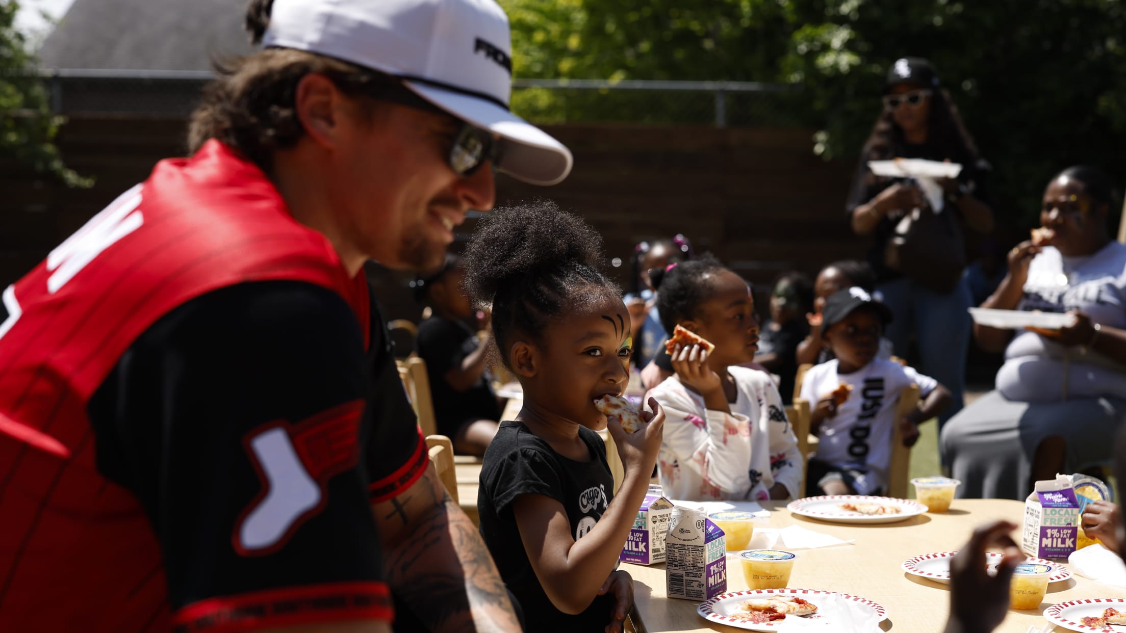 Davis Martin hangs out with kids having a meal.