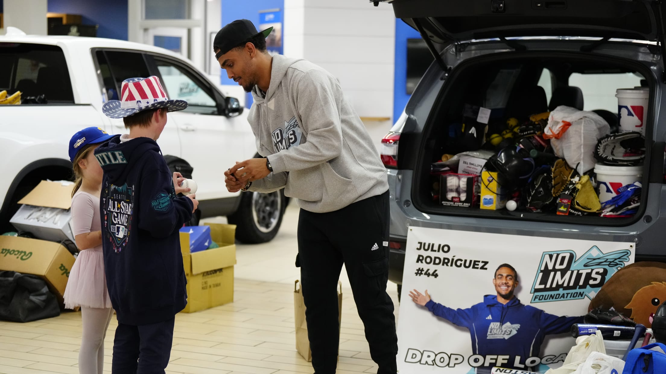 Julio Rodriguez gives out equipment at a No Limits Foundation equipment drive.
