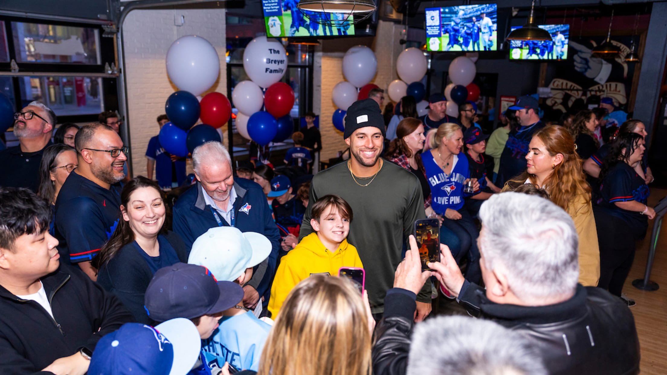 George Springer takes pictures with fans at a bowling event.