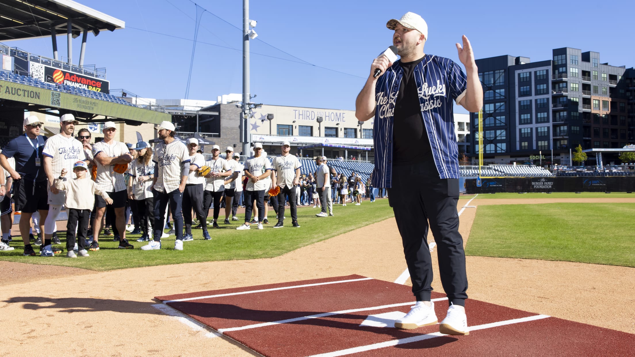 Jake Burger takes the mic to talk to participants of the Celebrity Softball Game.