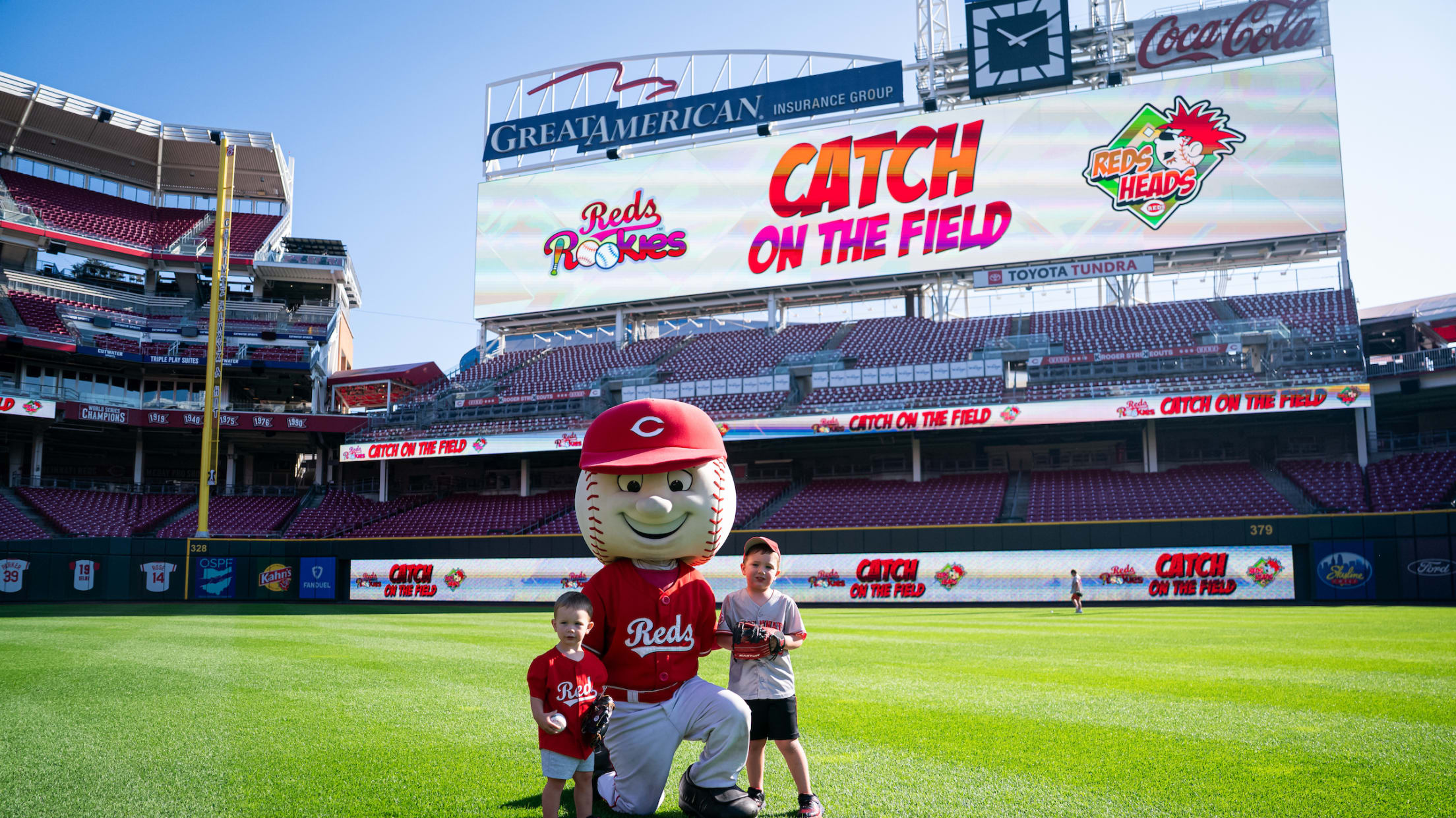Reds Rookies members with Mr. Red during Reds Heads Catch on Field event at the ballpark.
