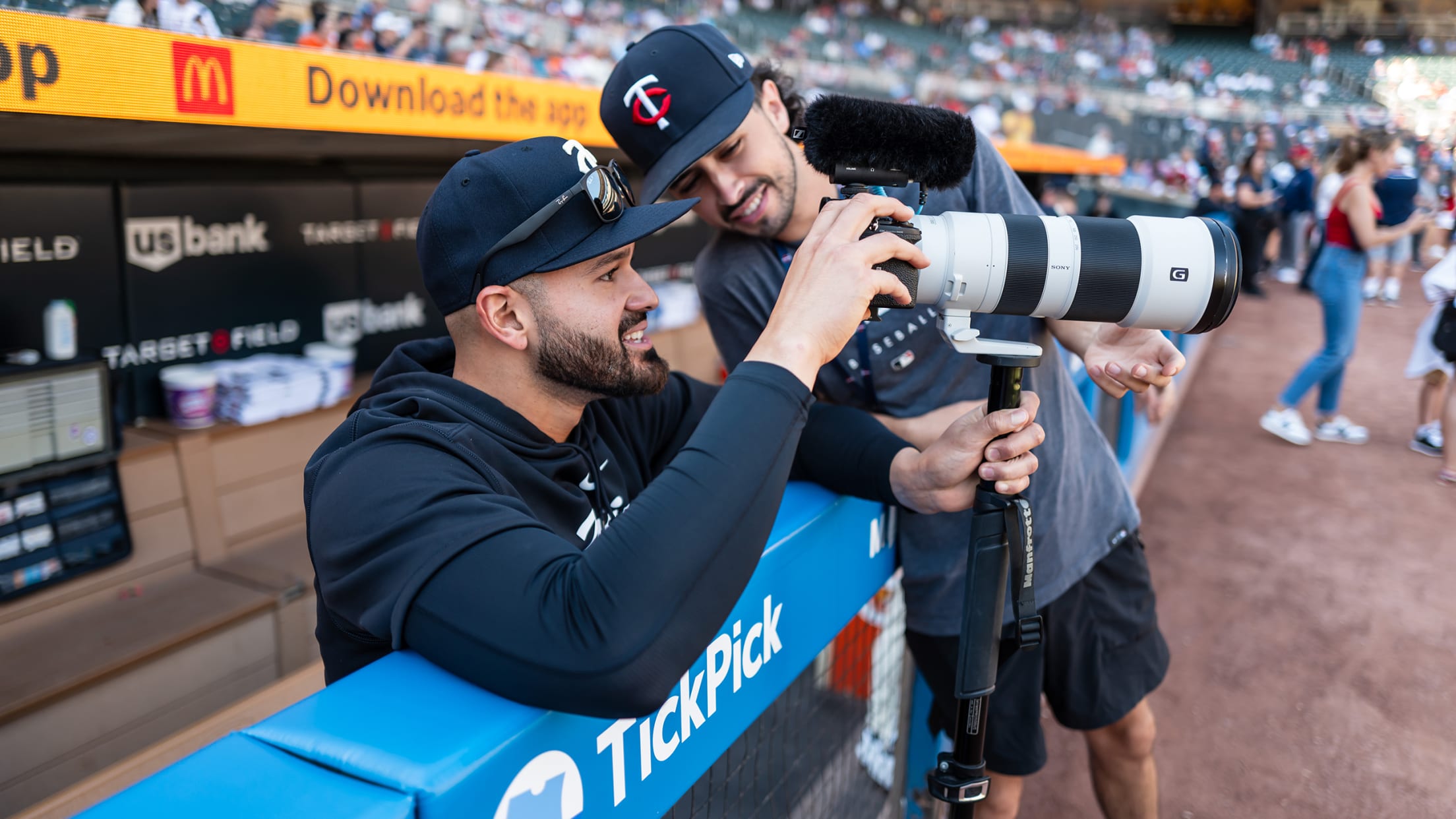 Pablo López getting a photography lesson from a Minnesota Twins employee