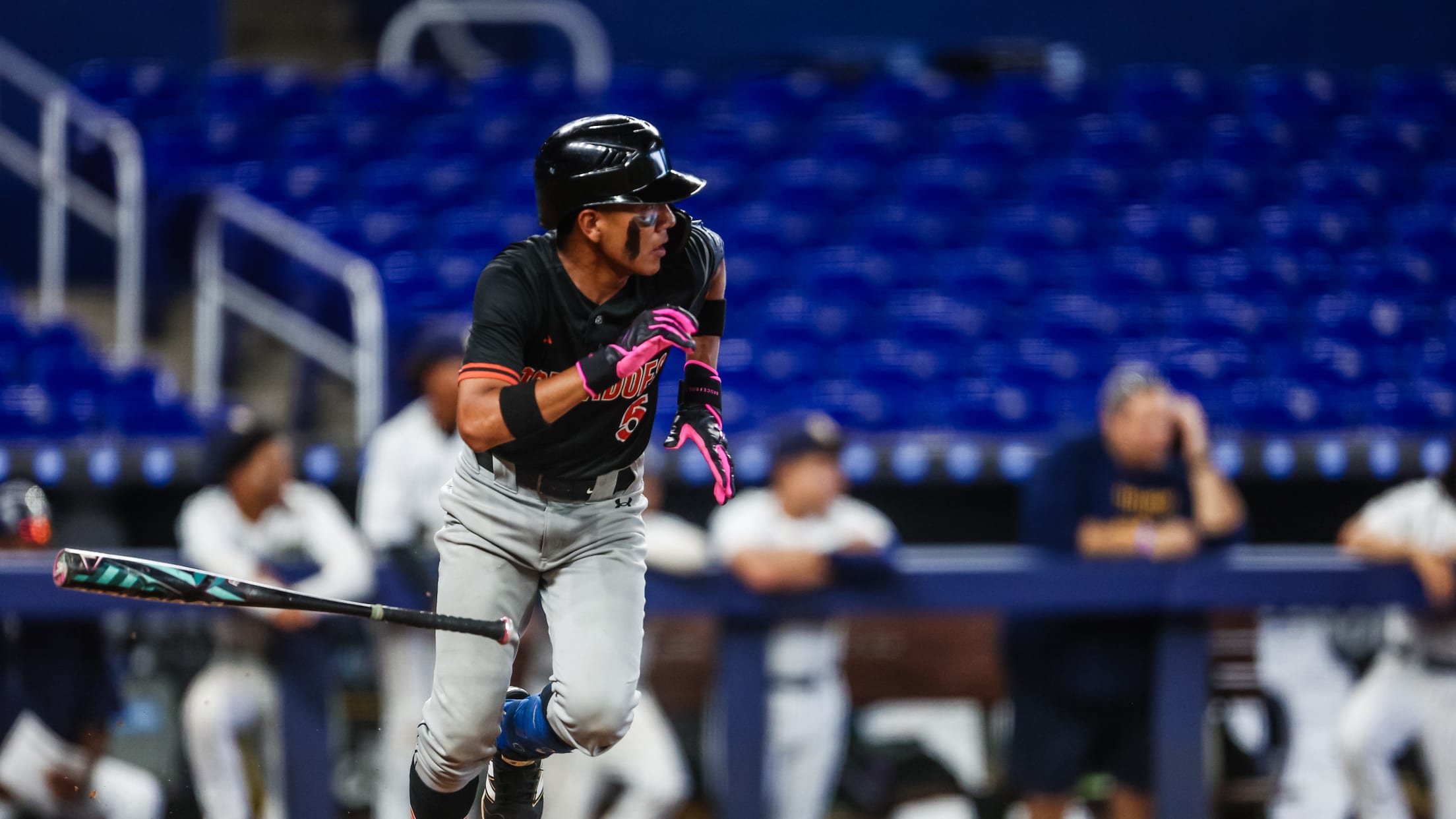 The batter takes off running to first base during the Jackie Robinson Classic.