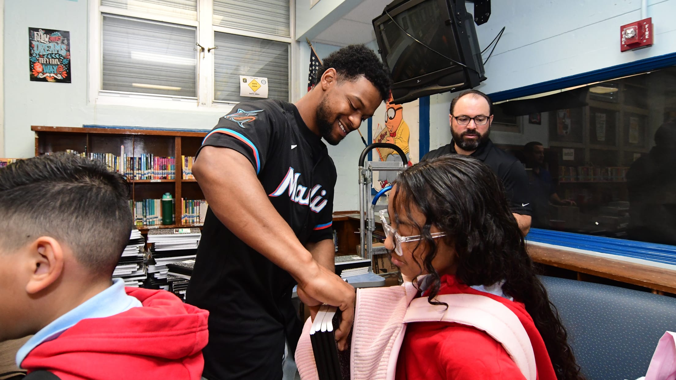 Otto Lopez gives away supplies to students at Kensington Park Elementary.