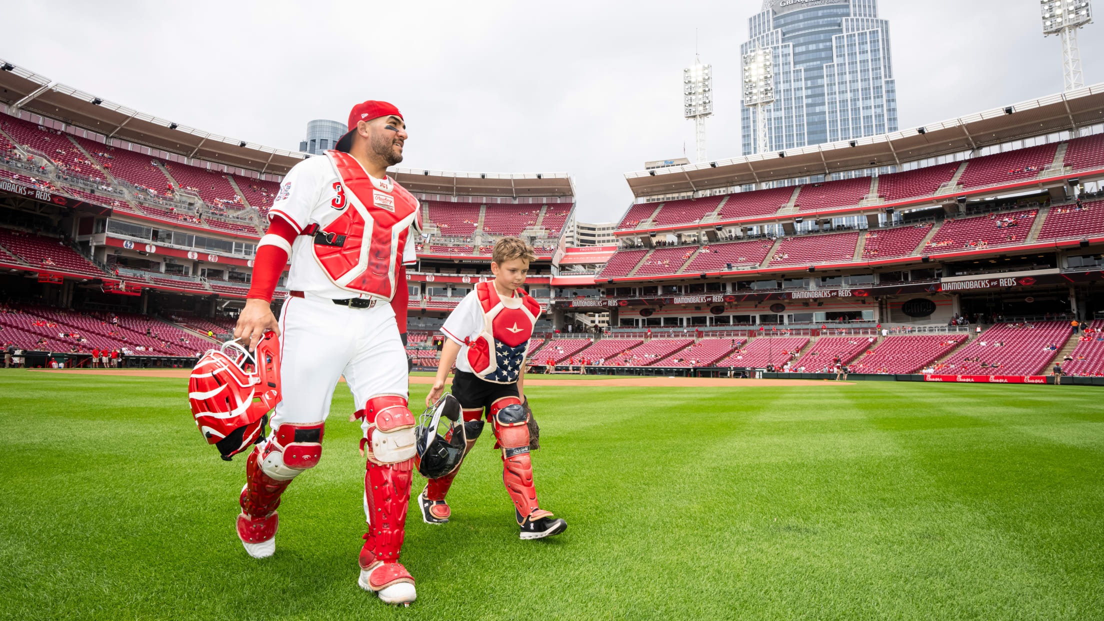 Jose Trevino takes the field with child from the Make-A-Wish foundation.