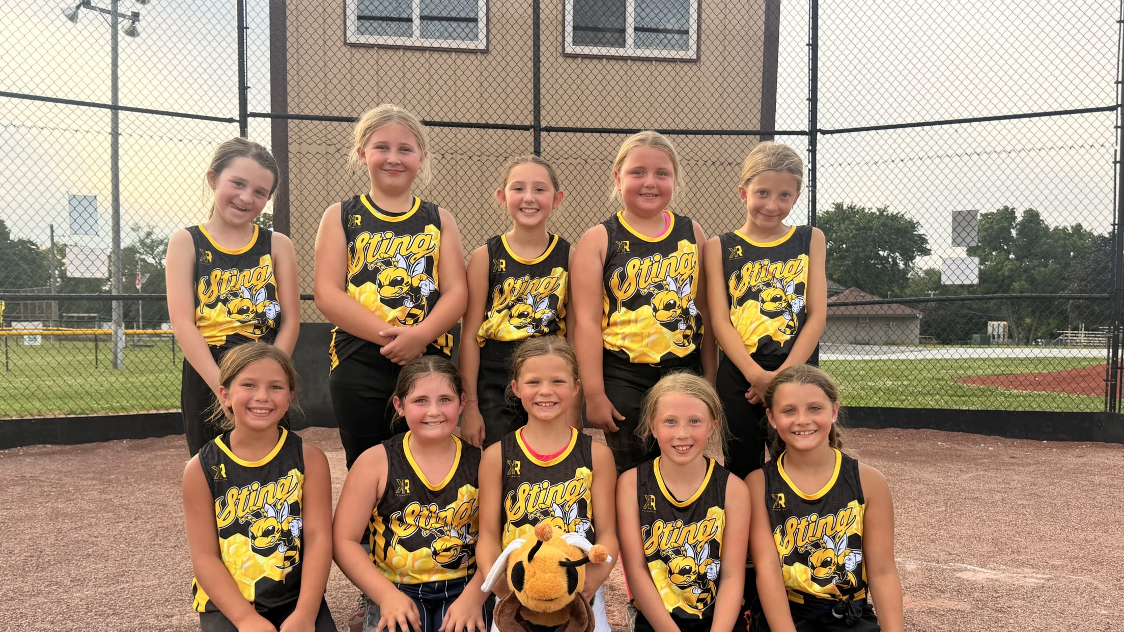 Girls from the Sting softball team pose for a team photo.