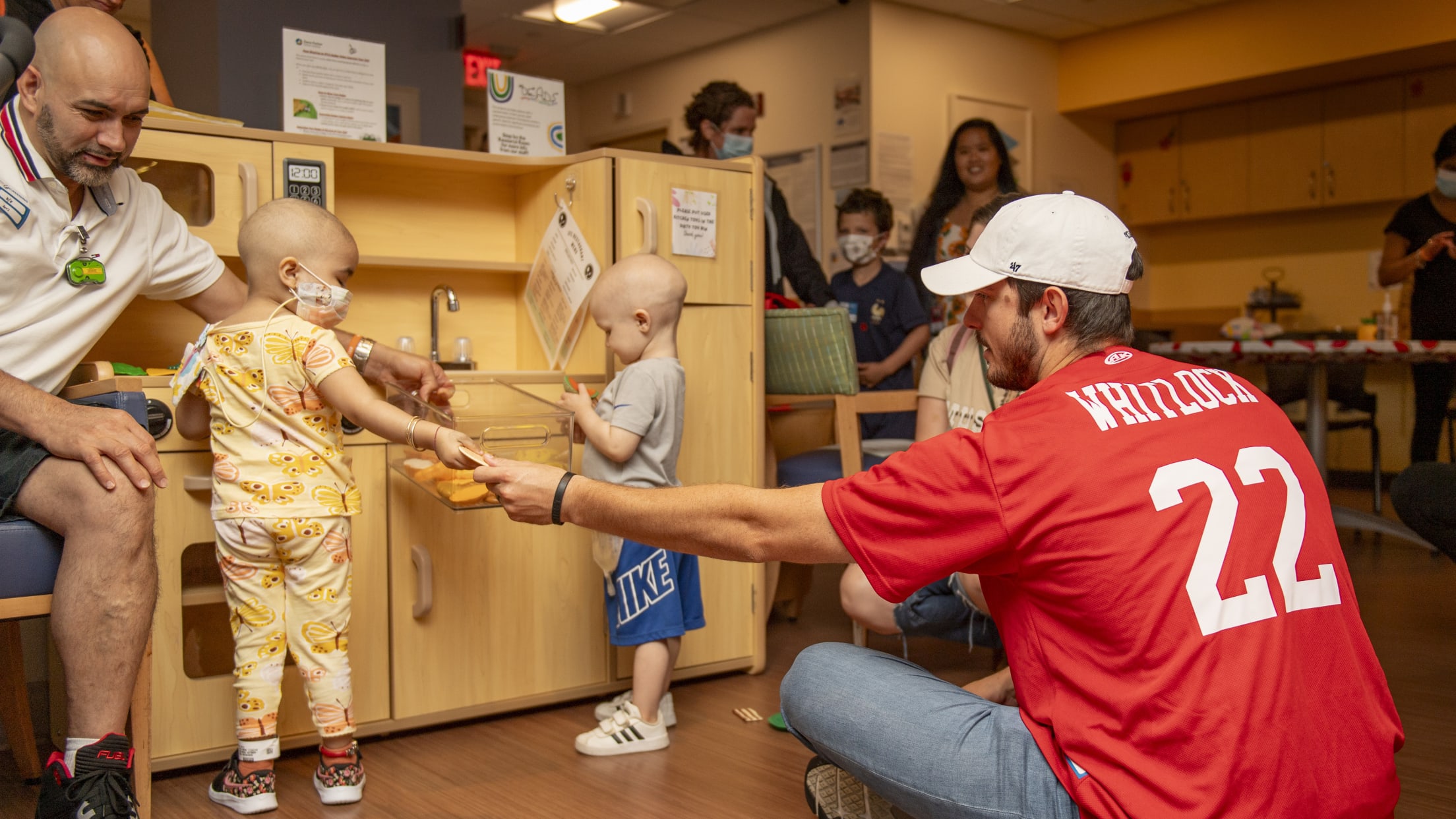 Garrett Whitlock plays kitchen with pediatric patients at Dana-Farber Cancer Institute.