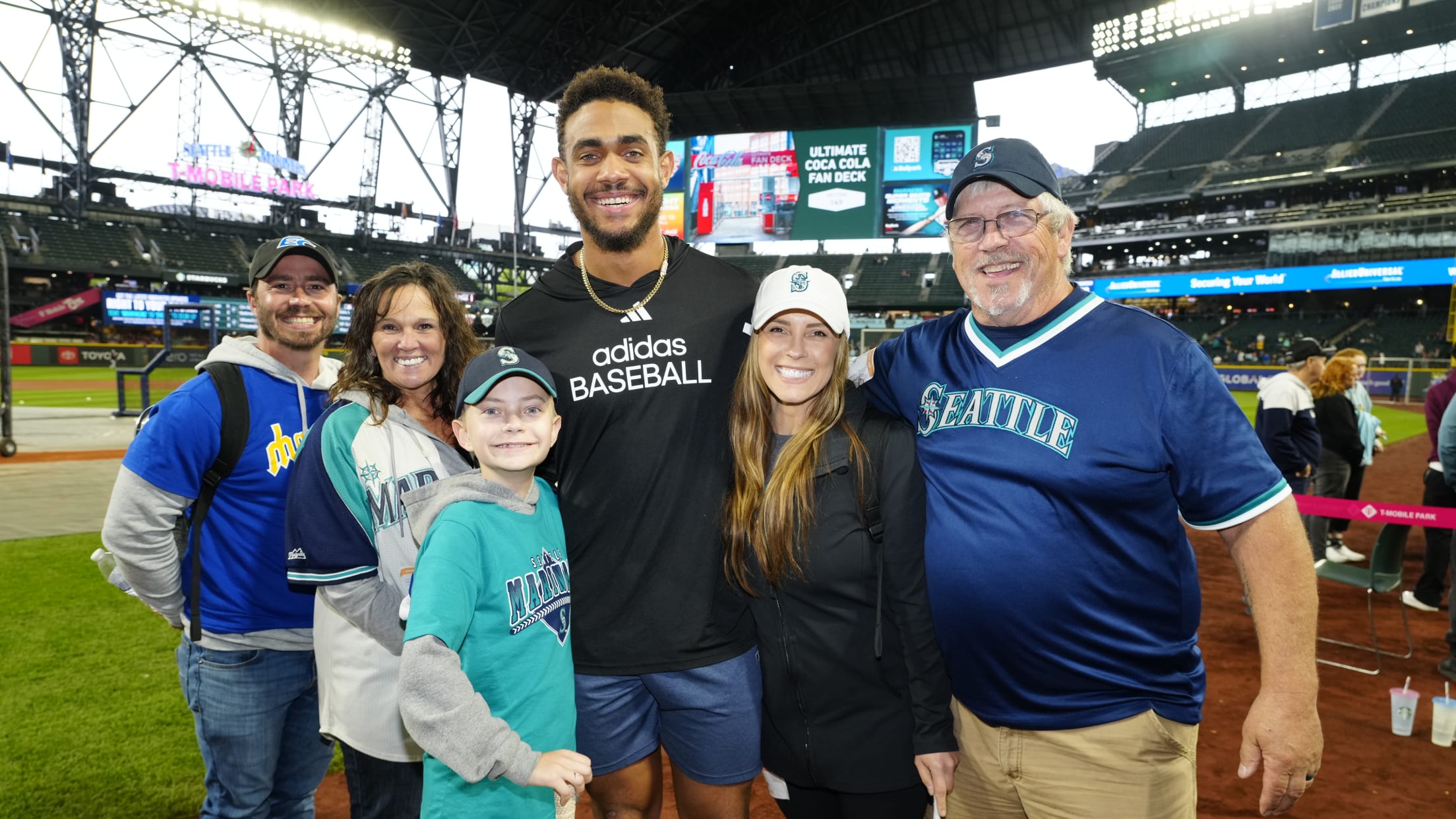 Julio Rodriguez takes a picture with Seattle Mariners fans visiting T-Mobile Park from Seattle Children's Hospital.