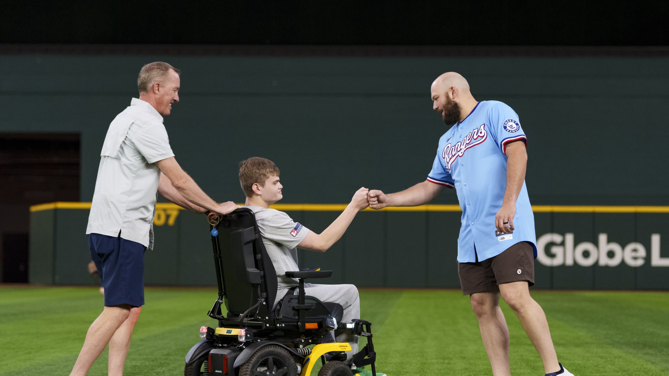 Jake Burger fist bumps a fan during the Make-A-Wish Field Day at Globe Life Field.