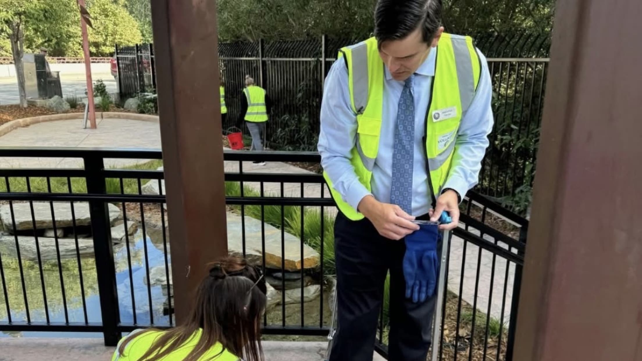 Two volunteers clean at a park.
