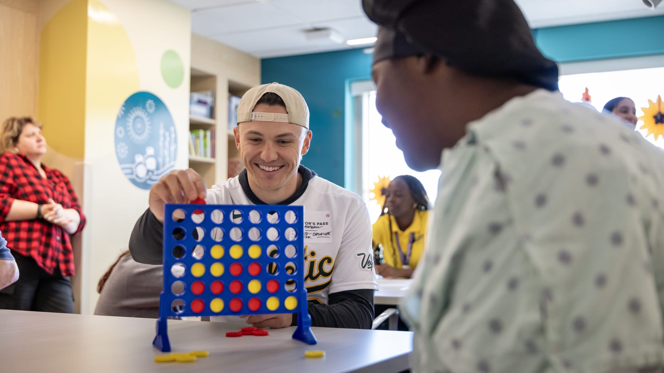 Zack Gelof plays connect with a patient at Shriners Children's Hospital.