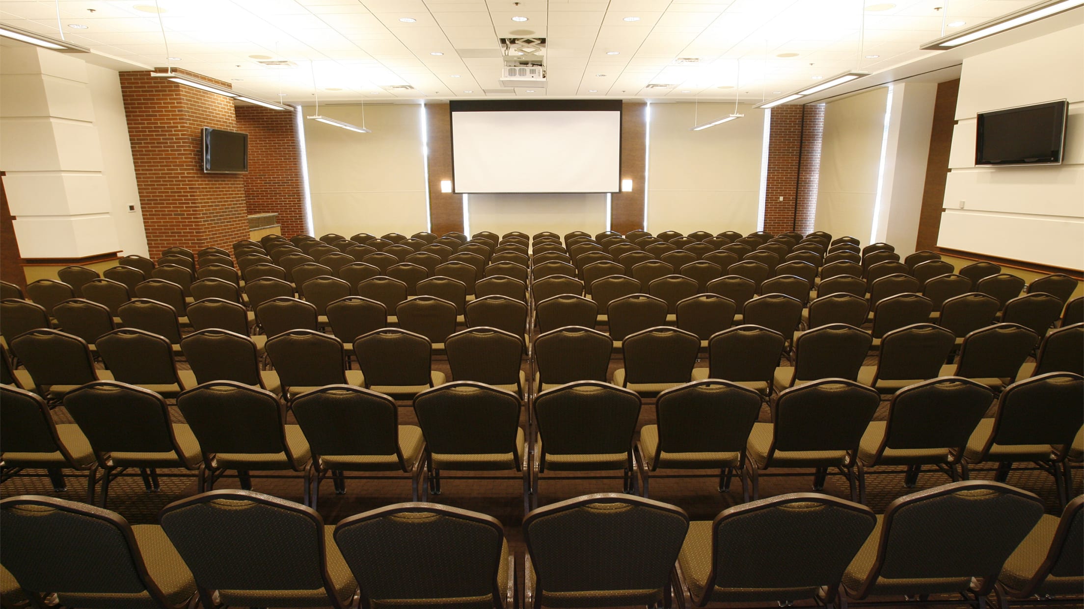 Conference Room 2 with theater style chair setup with projector display