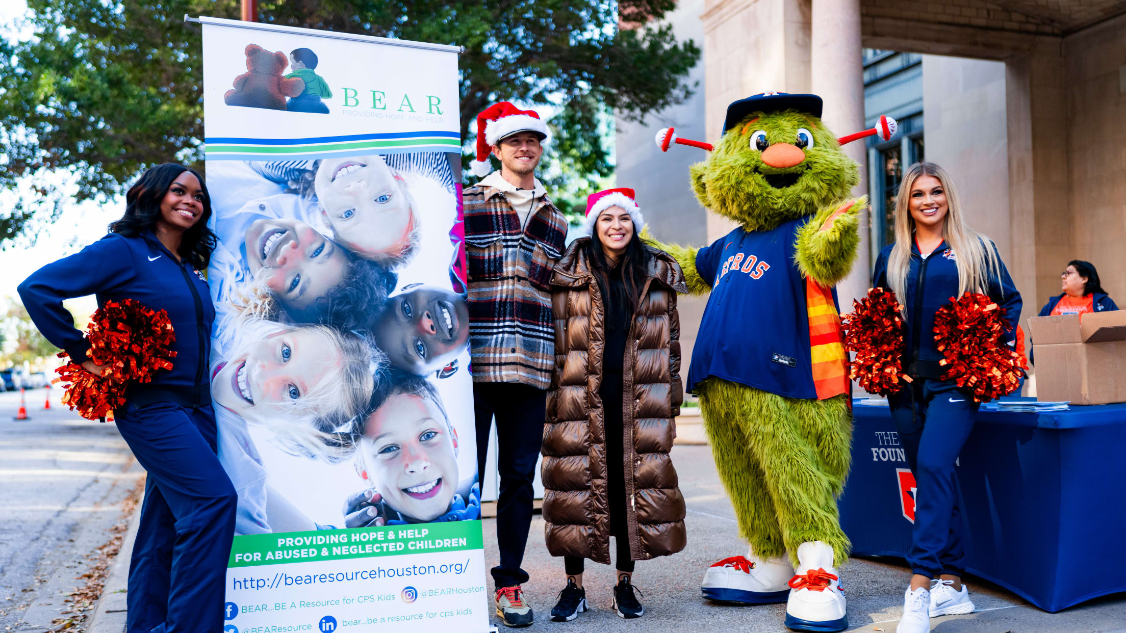 Josh Hader takes a picture next to a BEAR Houston sign, a local non-profit supporting abused and neglected children.