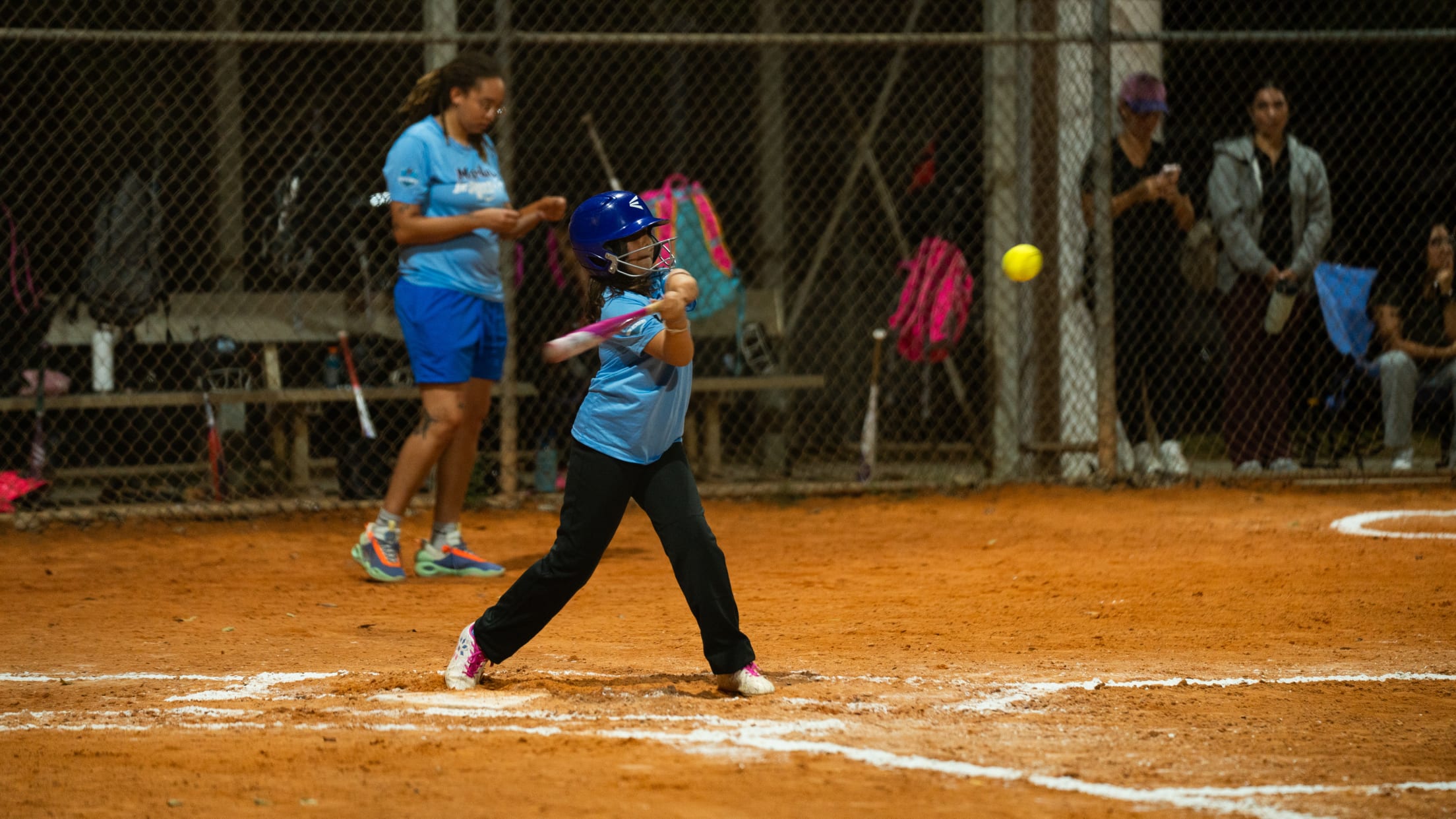 The batter swings at the incoming pitch during the Marlins Nike Jr. RBI program.