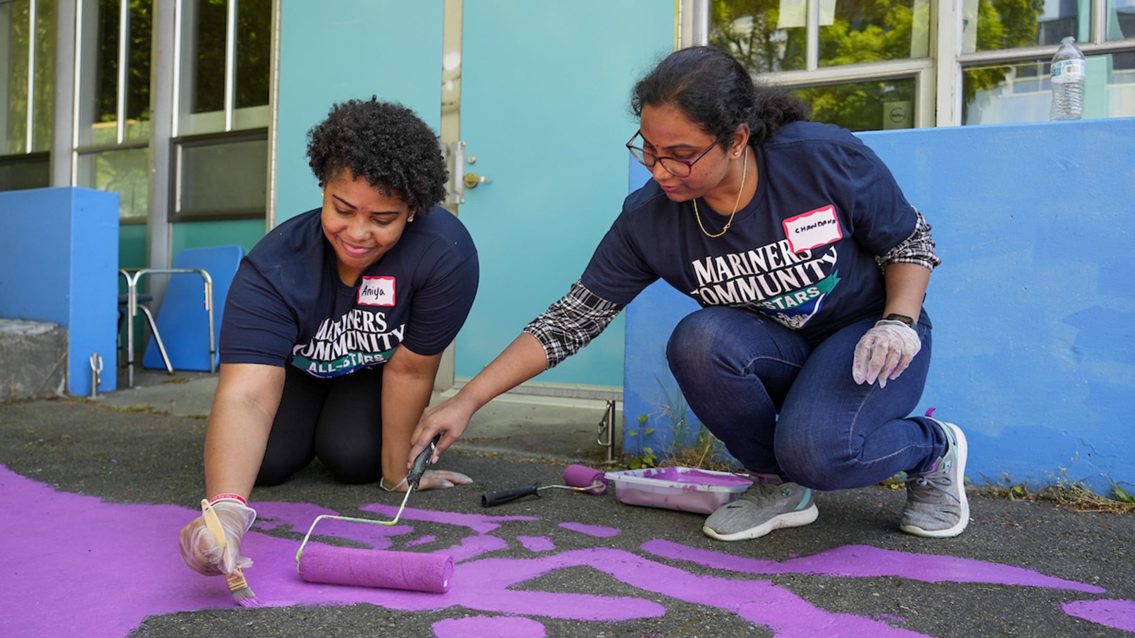 Mariners Community All-Stars painting sidewalk.