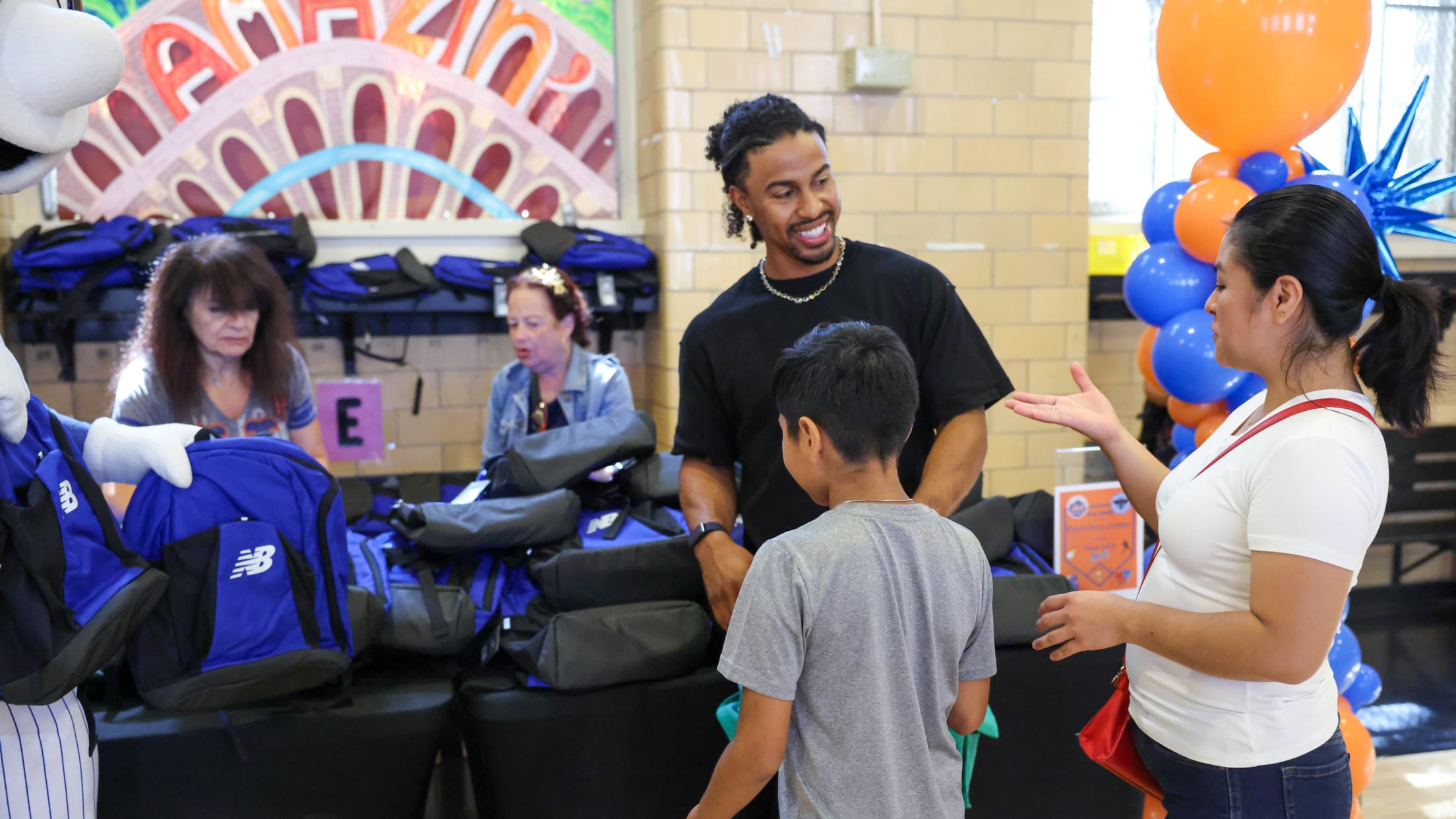 Francisco Lindor meets with students and family as he gives away free backpacks at a New York City school.