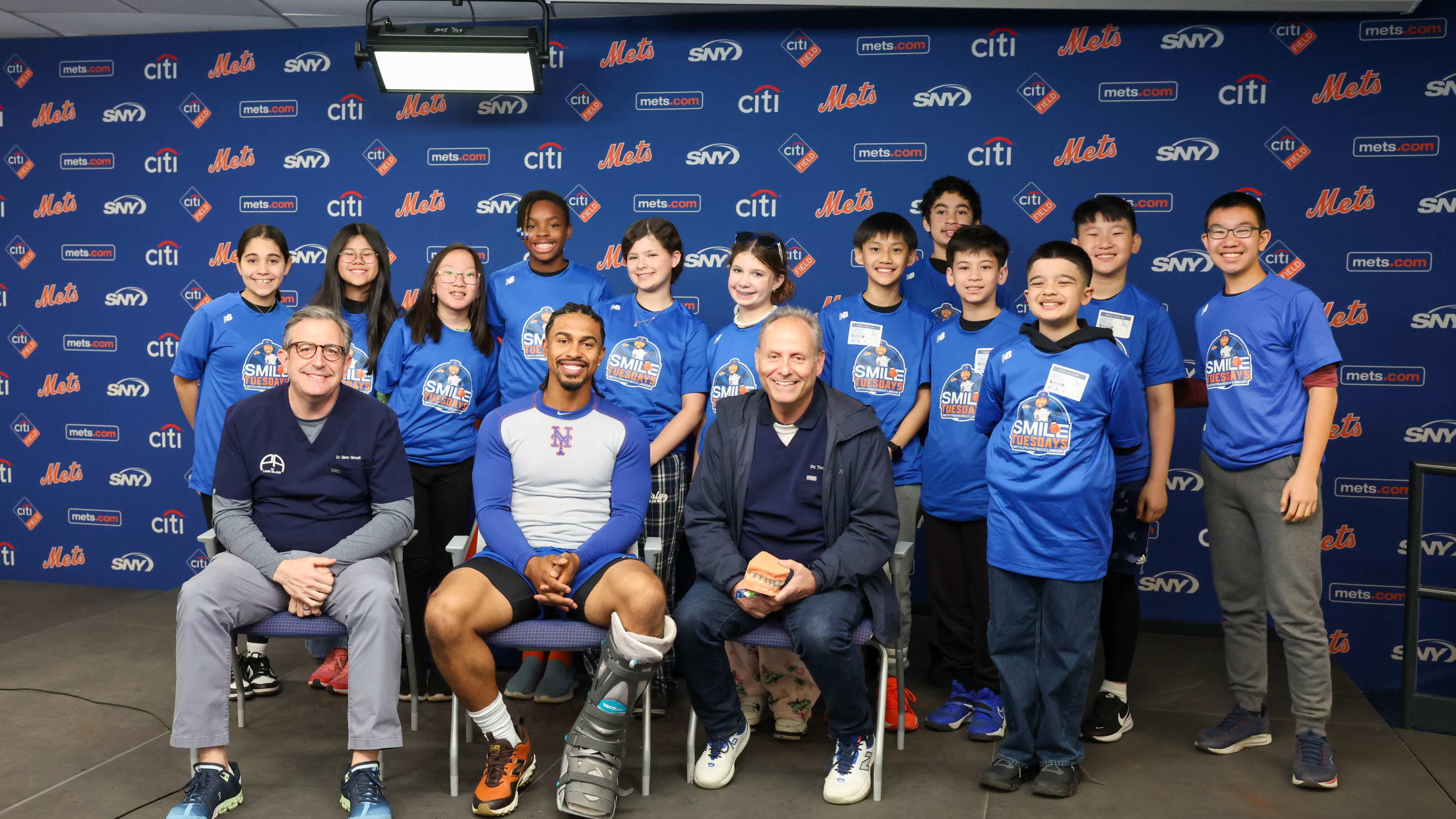 Francisco Lindor takes a photo with a group participating in Smile Tuesdays.