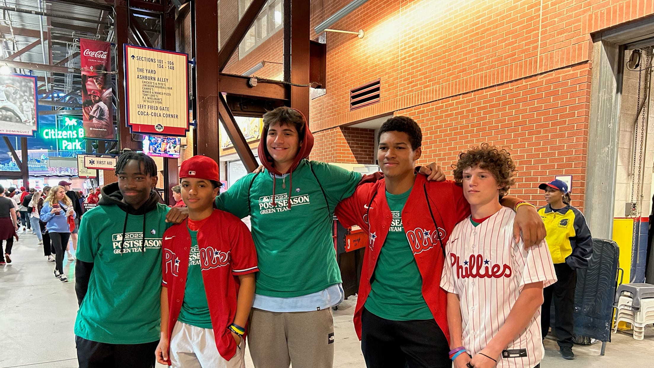 Green Team members pose for a photo during a postseason game at Citizens Bank park.
