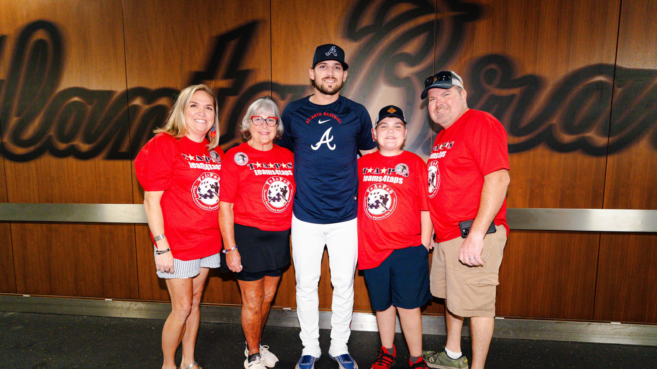 Austin Riley takes a picture with a military family with Operations Home Team at Truist Park.
