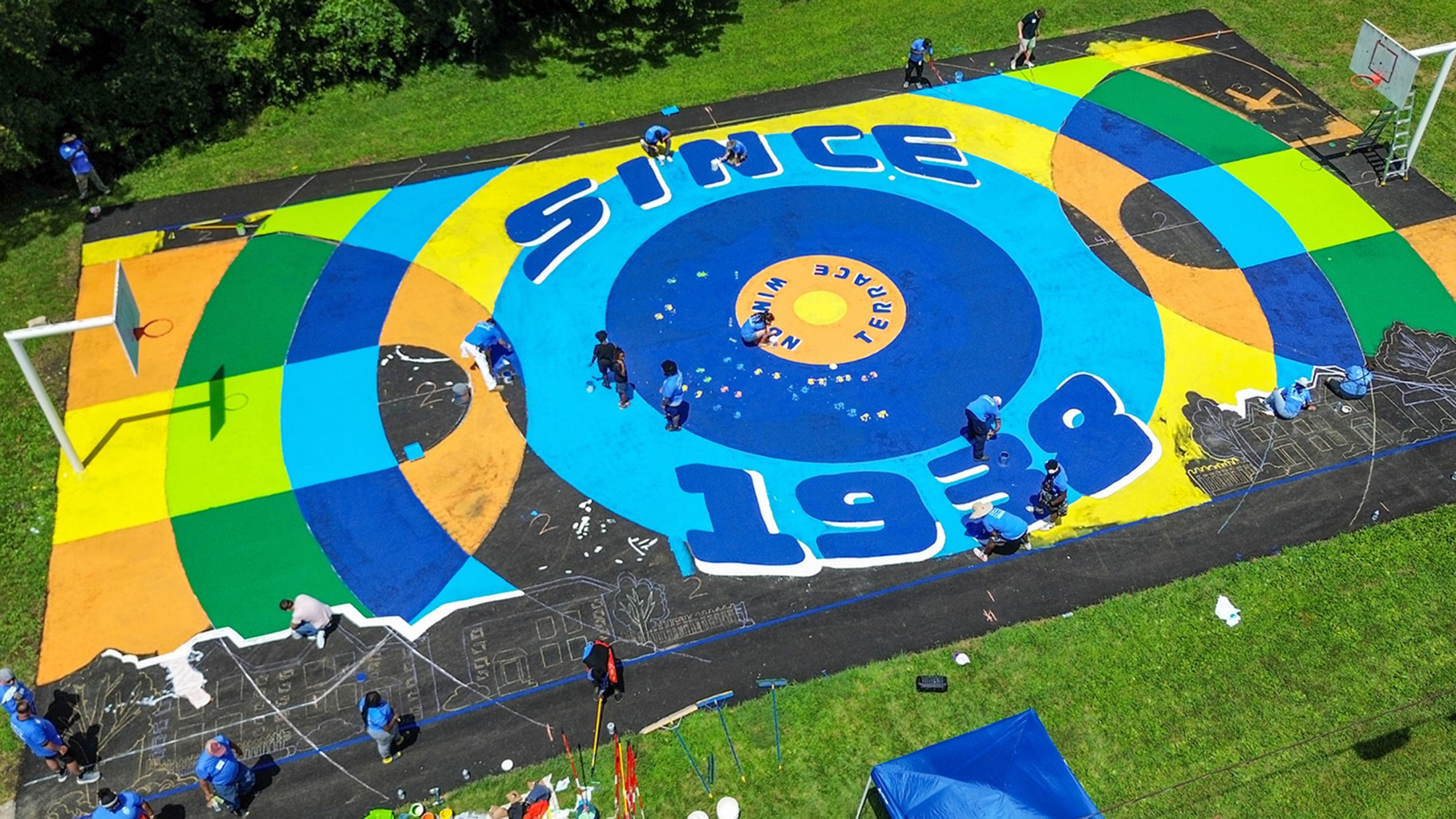 Cleaning a community basketball court.