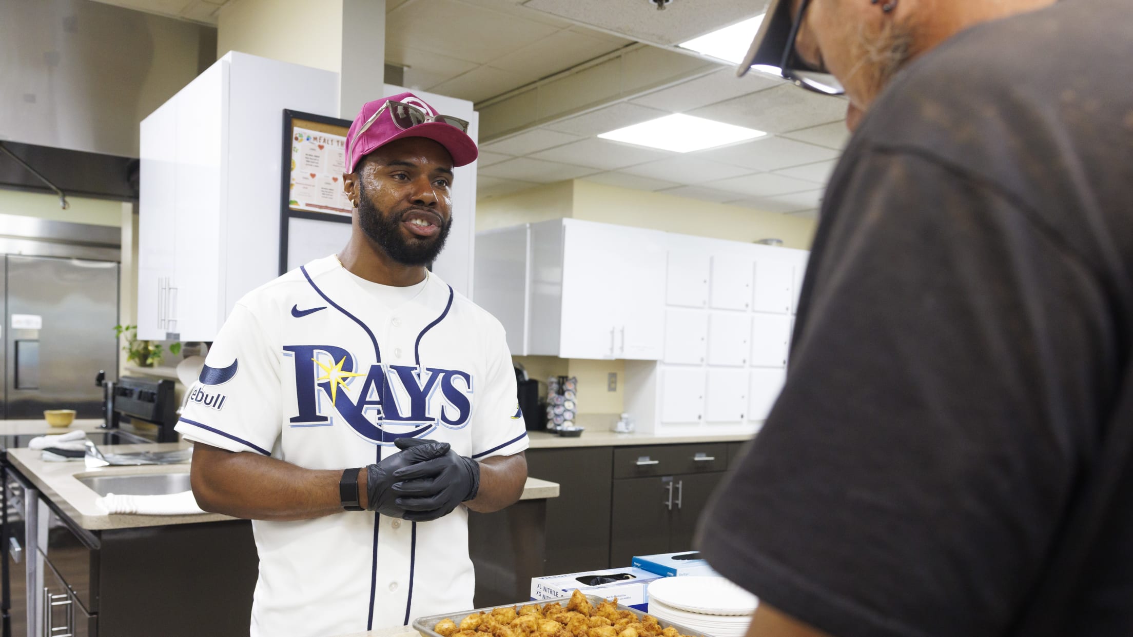 Cedric Mullins helps cook food at the Ronald McDonalds House.