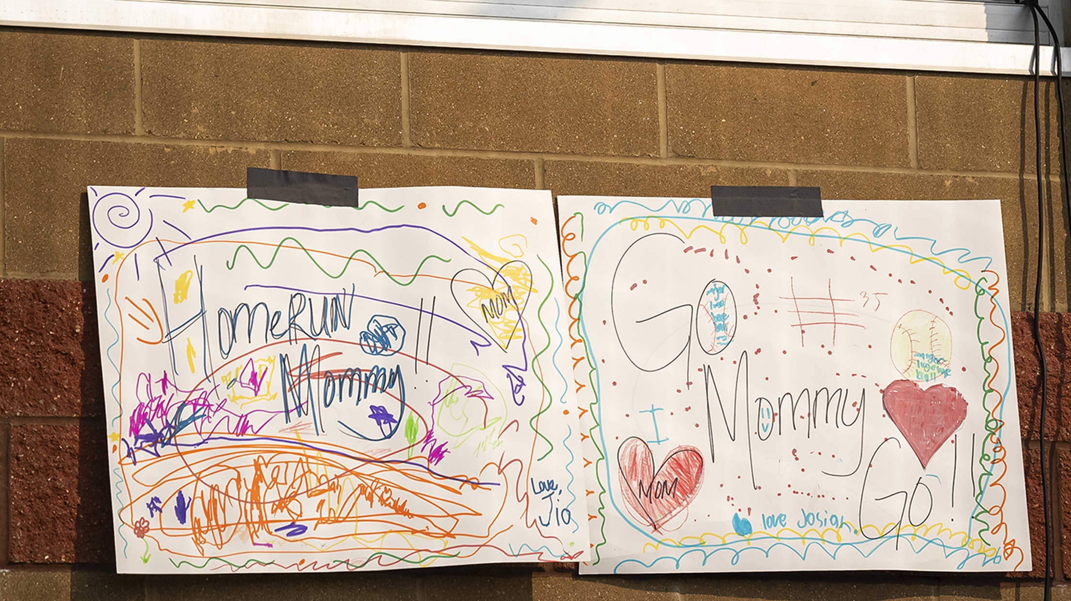 Signs cheering on the Reds wives made by their children.