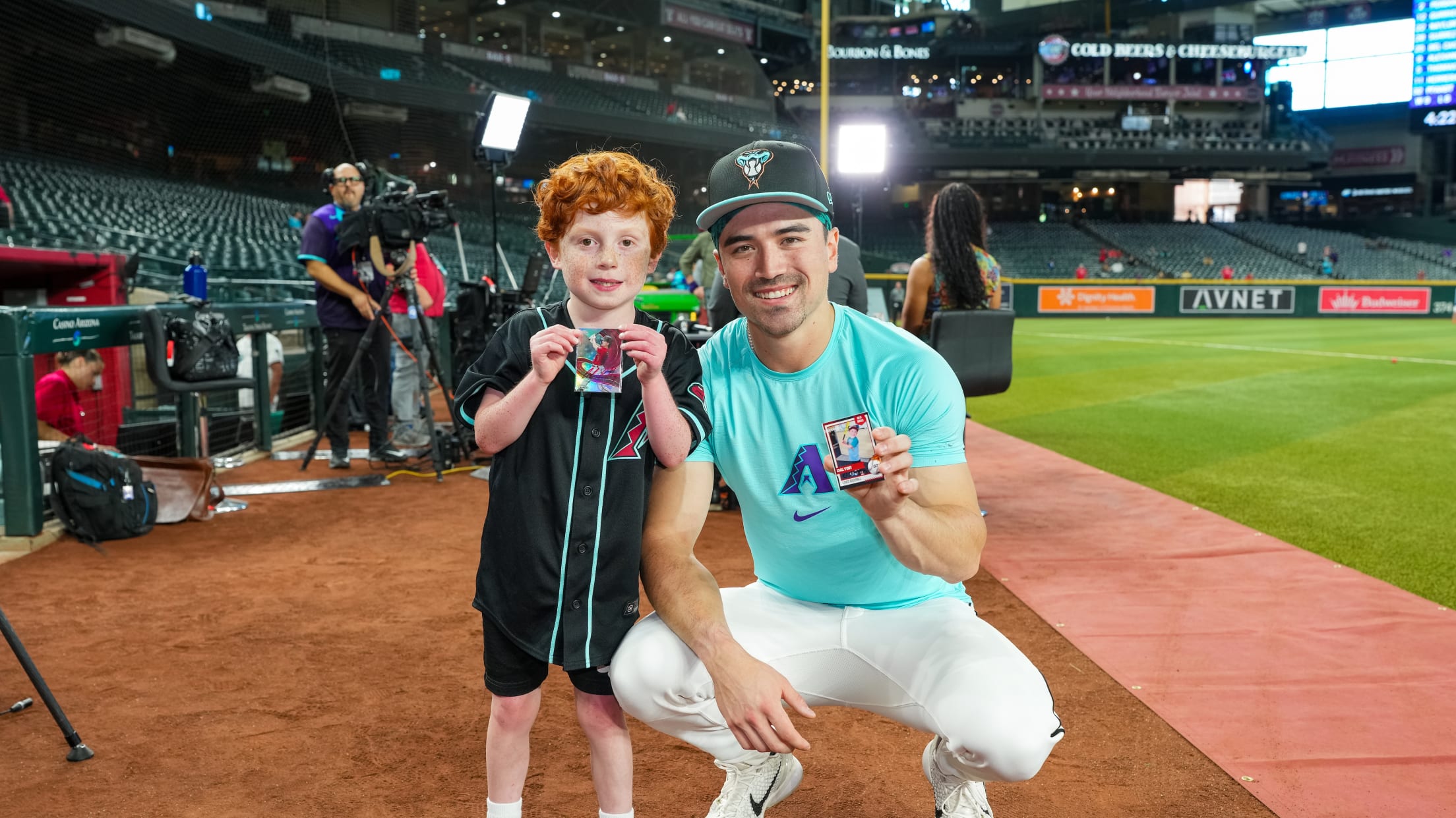 Corbin Carroll shows off his baseball cards with a fan.