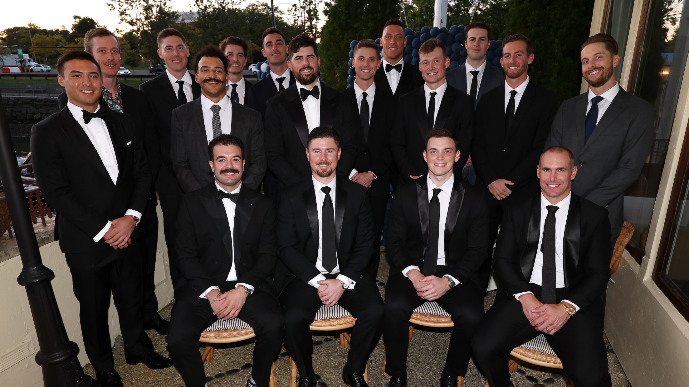 Members of the New York Yankees pose for a photo in their suits.