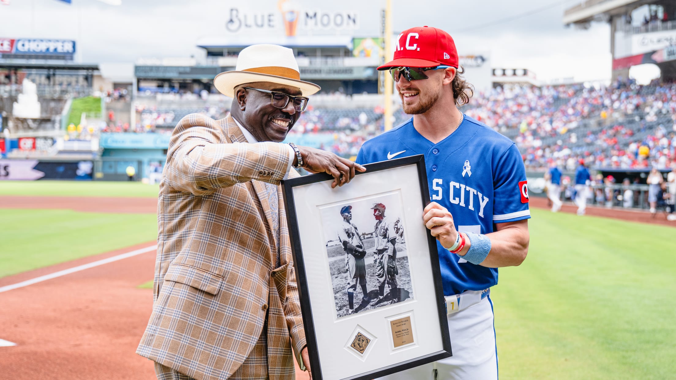Bobby Witt Jr. accepts a picture from Negro Leagues Baseball Museum president Bob Kendrick.