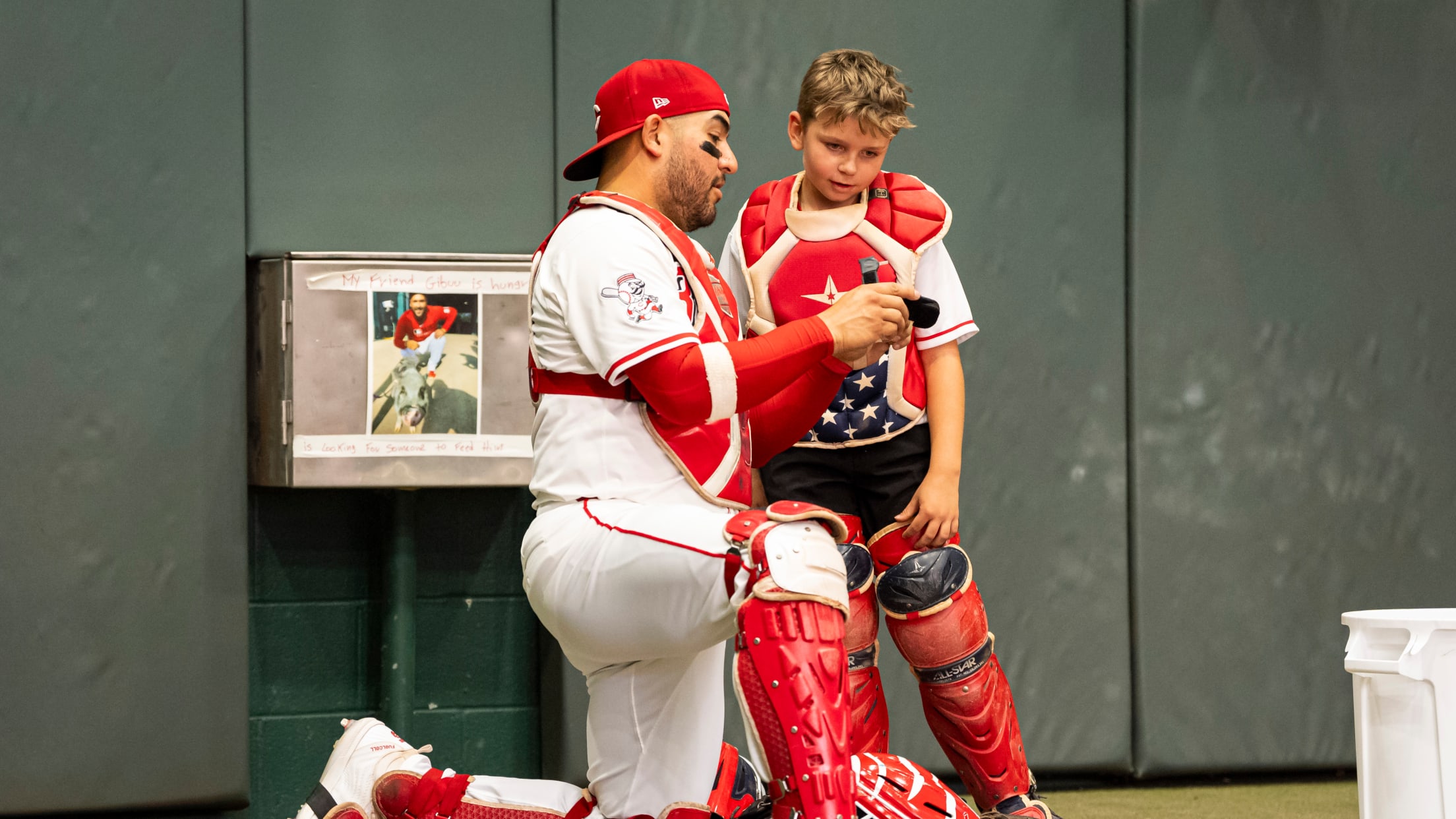 Jose Trevino shows a child from the Make-A-Wish Foundation the ropes of being a MLB catcher.