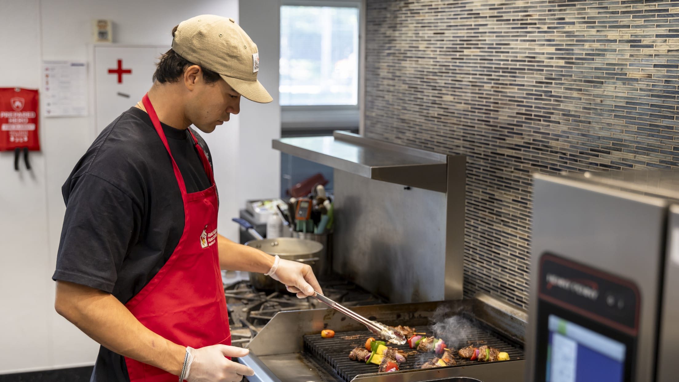 Joey Cantillo chefs it up in the kitchen cooking skewers at the Ronald McDonald House.