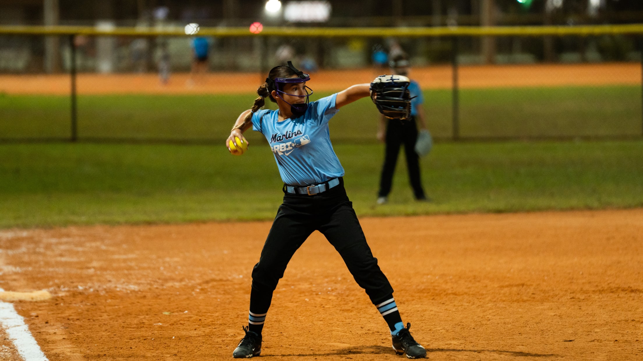 The third baseman winds up to throw from the infield dirt.
