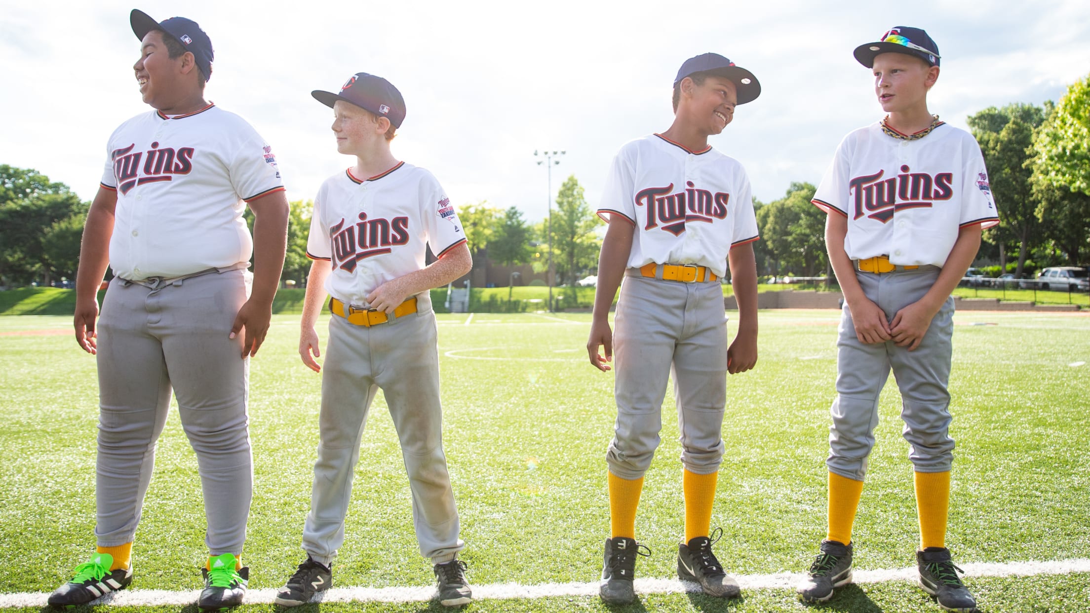 Four kids in Twins uniforms