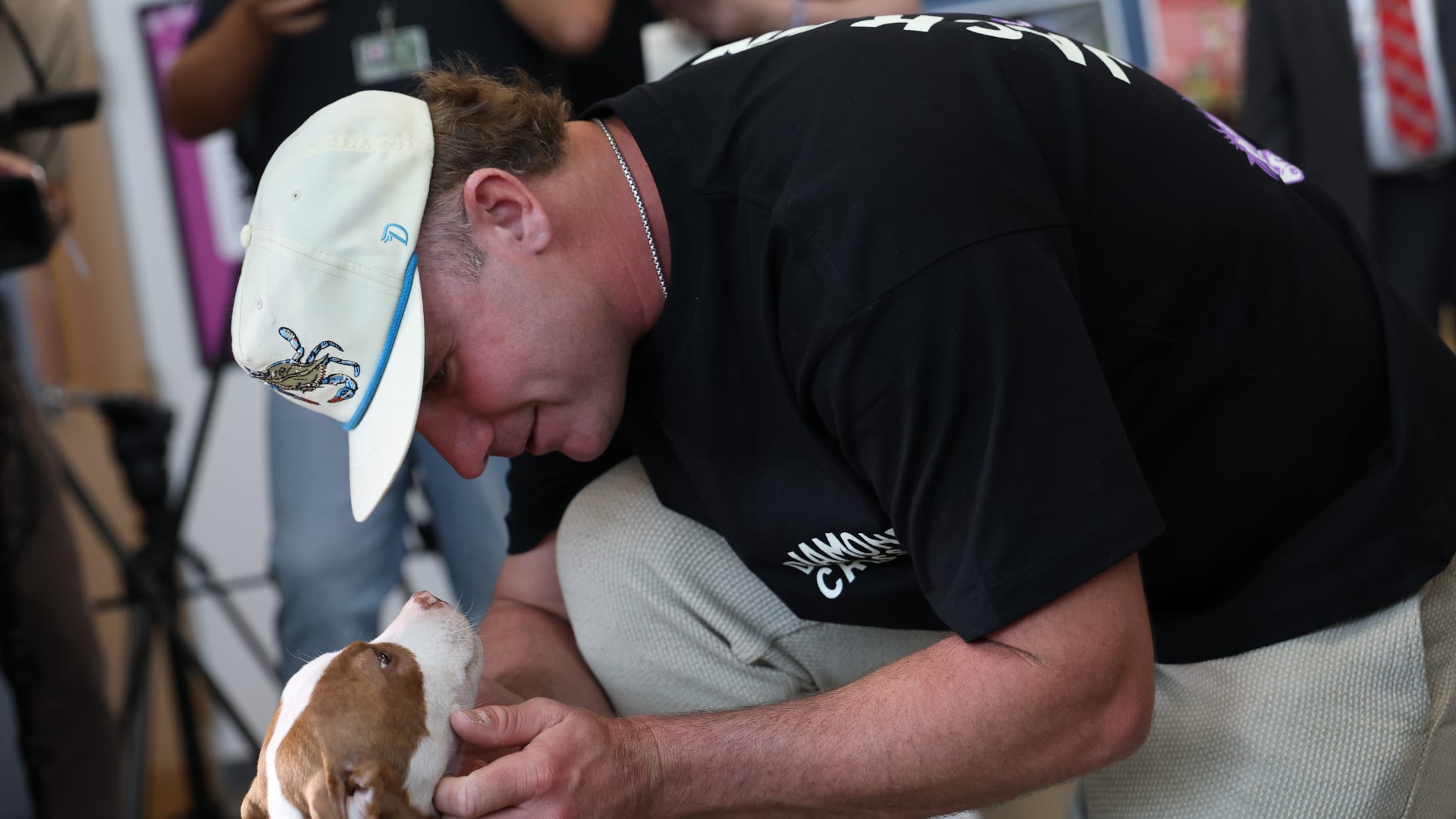 Pete Alonso plays with a pup at an event with Baltimore Animal Rescue and Care Shelter (BARCS).